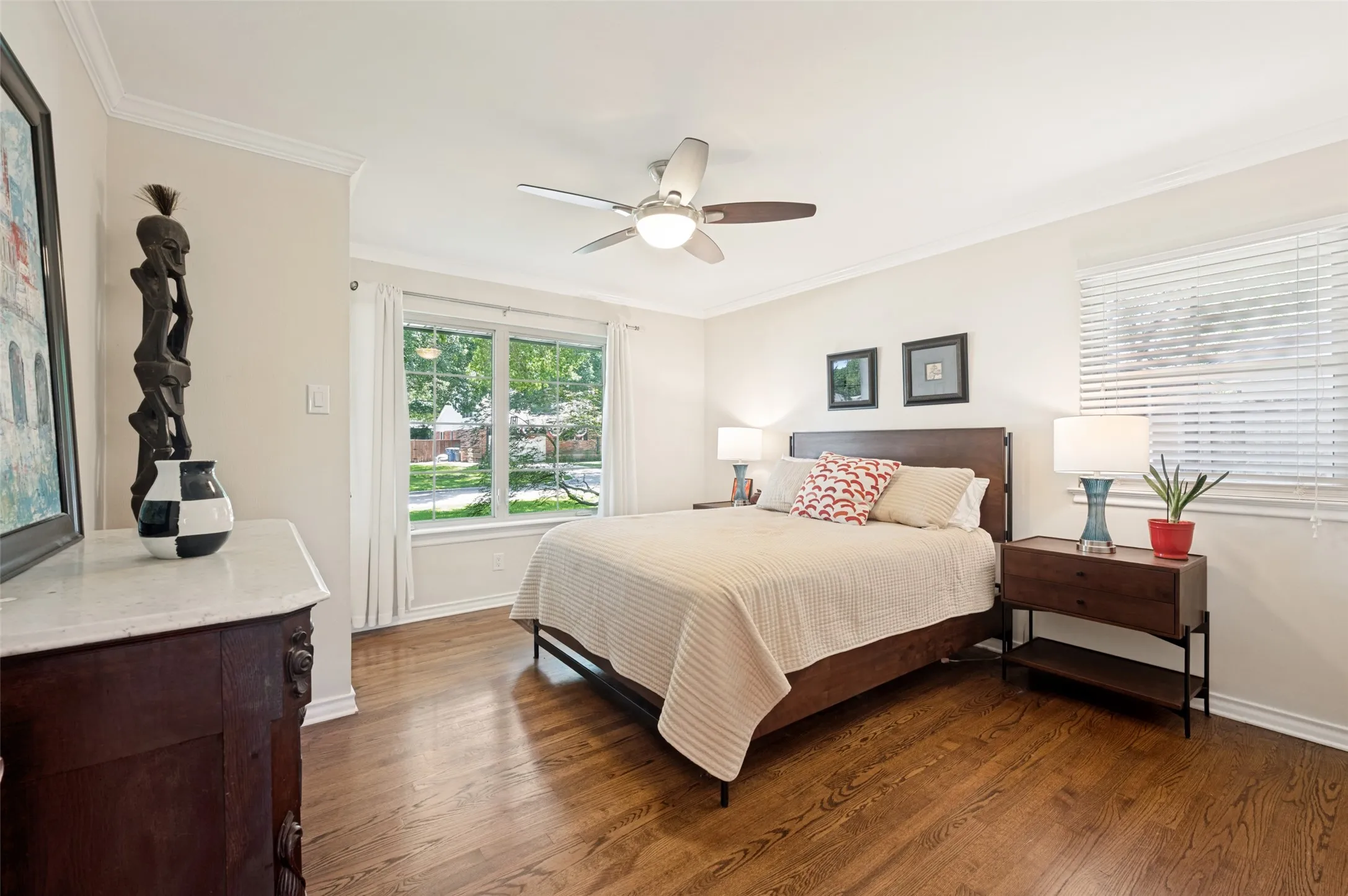 Hardwood flooring throughout, featuring a large window with exterior landscaping visible