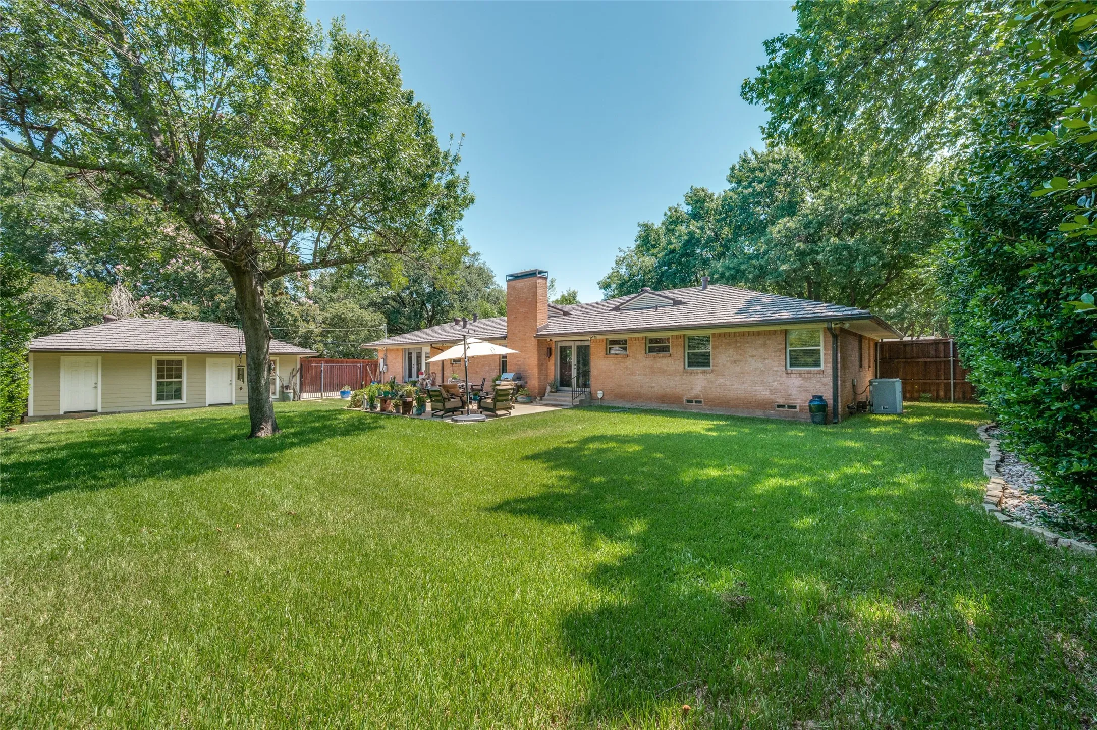Expansive green lawn with mature trees