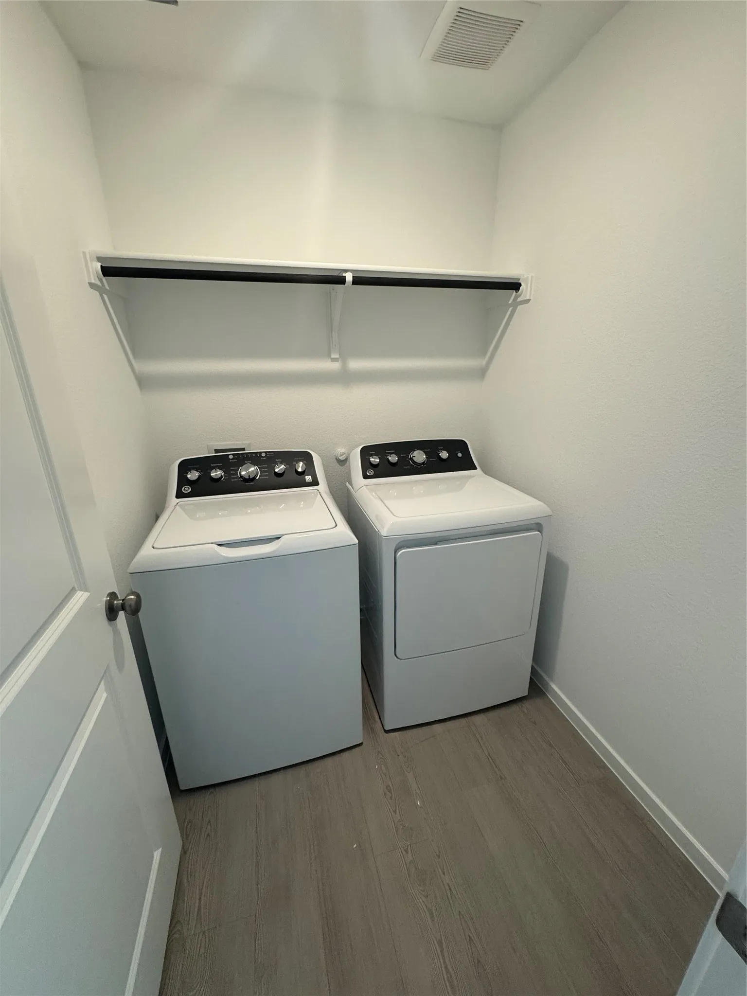 Washroom featuring light wood-style floors and independent washer and dryer