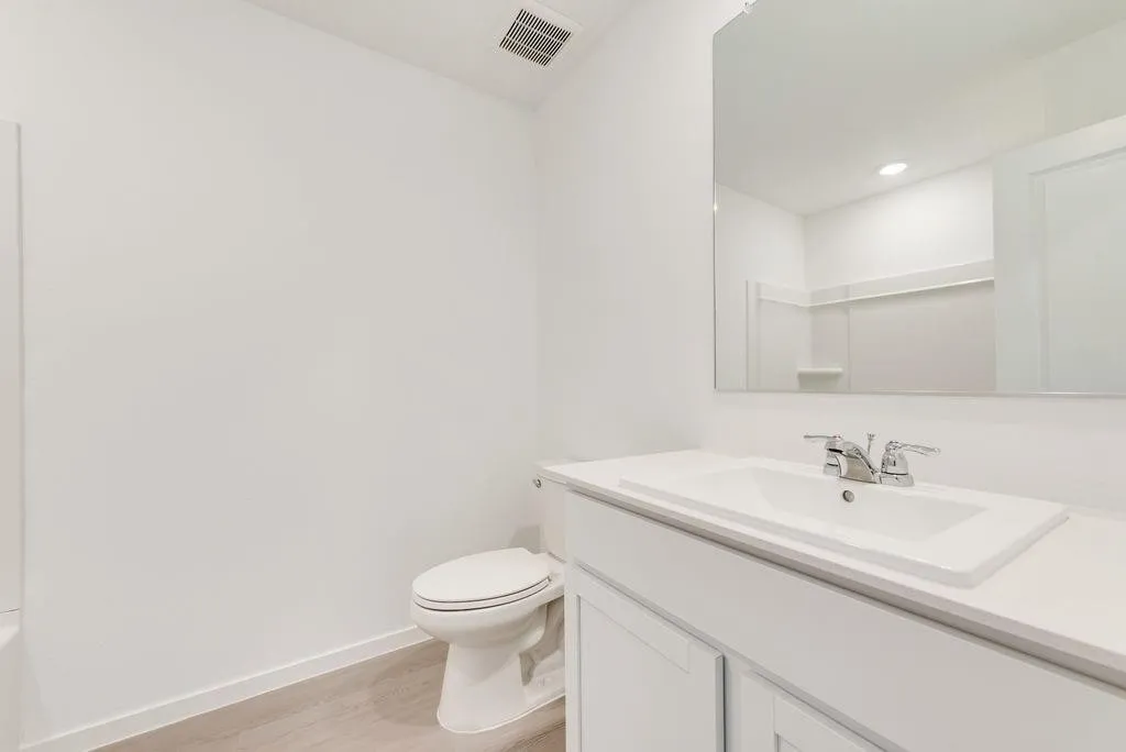 Bathroom with vanity and wood finished floors
