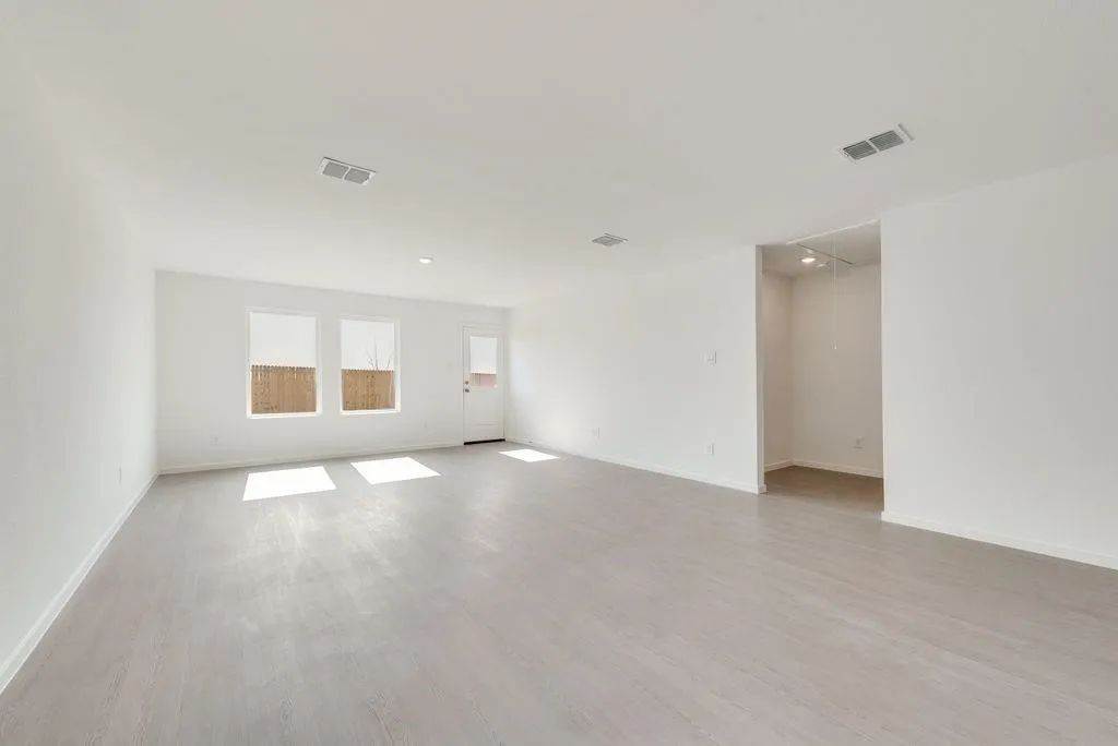 Spare room featuring wood finished floors