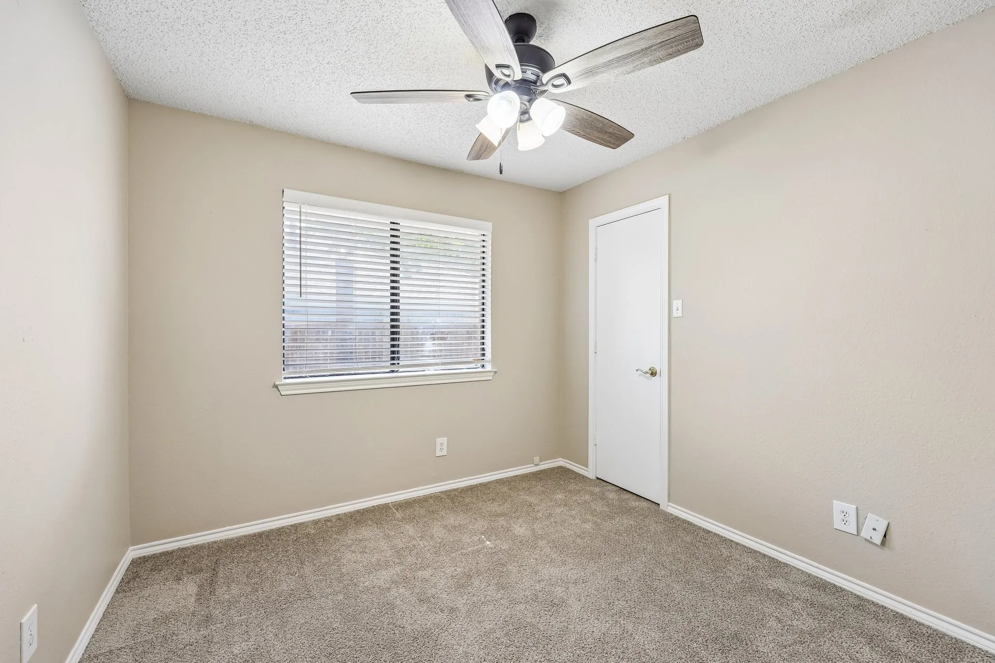Neutral-toned walls complement the gray carpeting