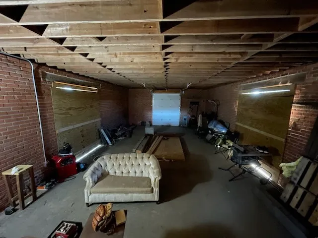 Below grade area featuring brick wall