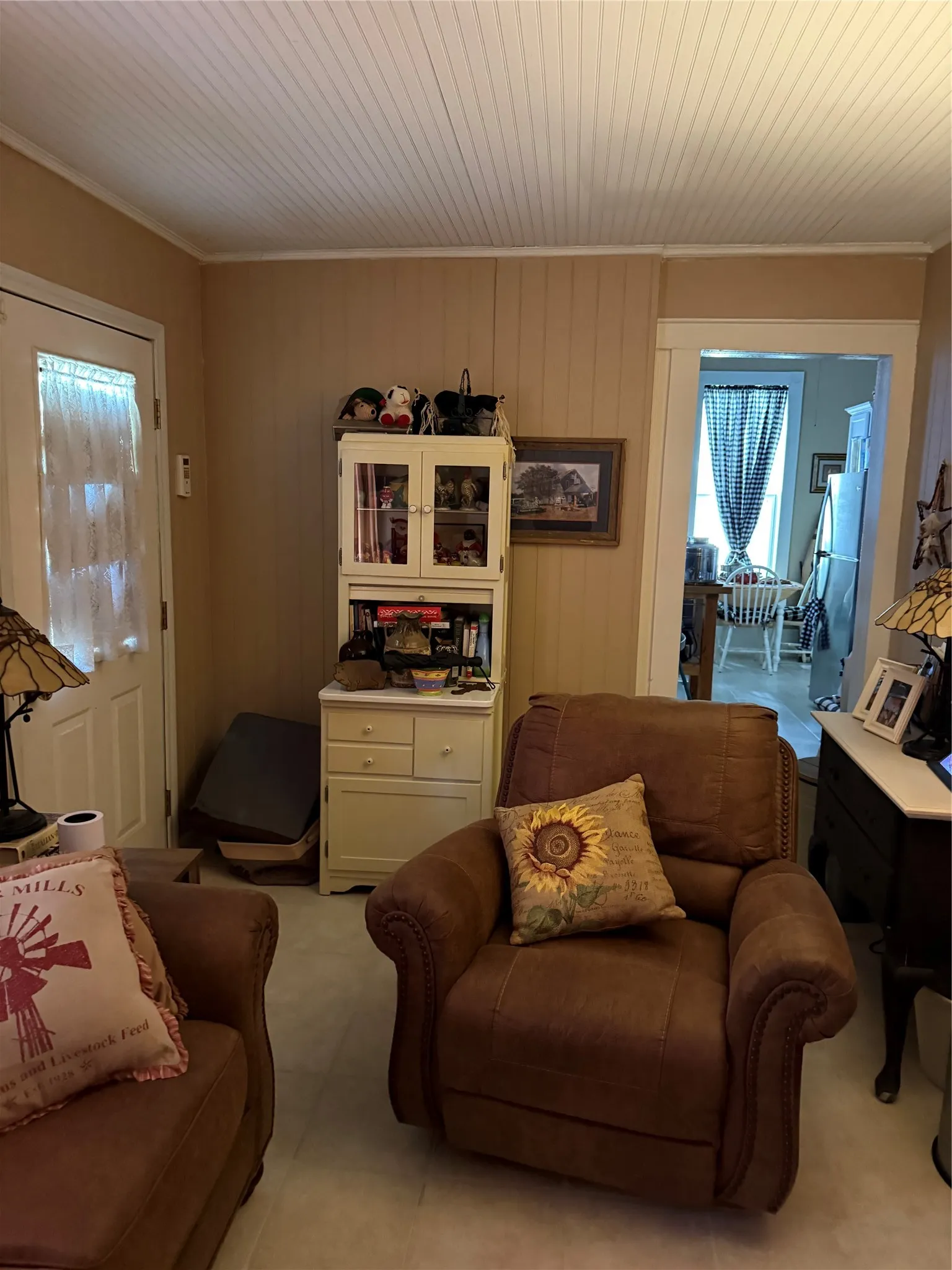 Interior room featuring beadboard ceiling, vertical plank wall paneling, and a light-toned flooring
