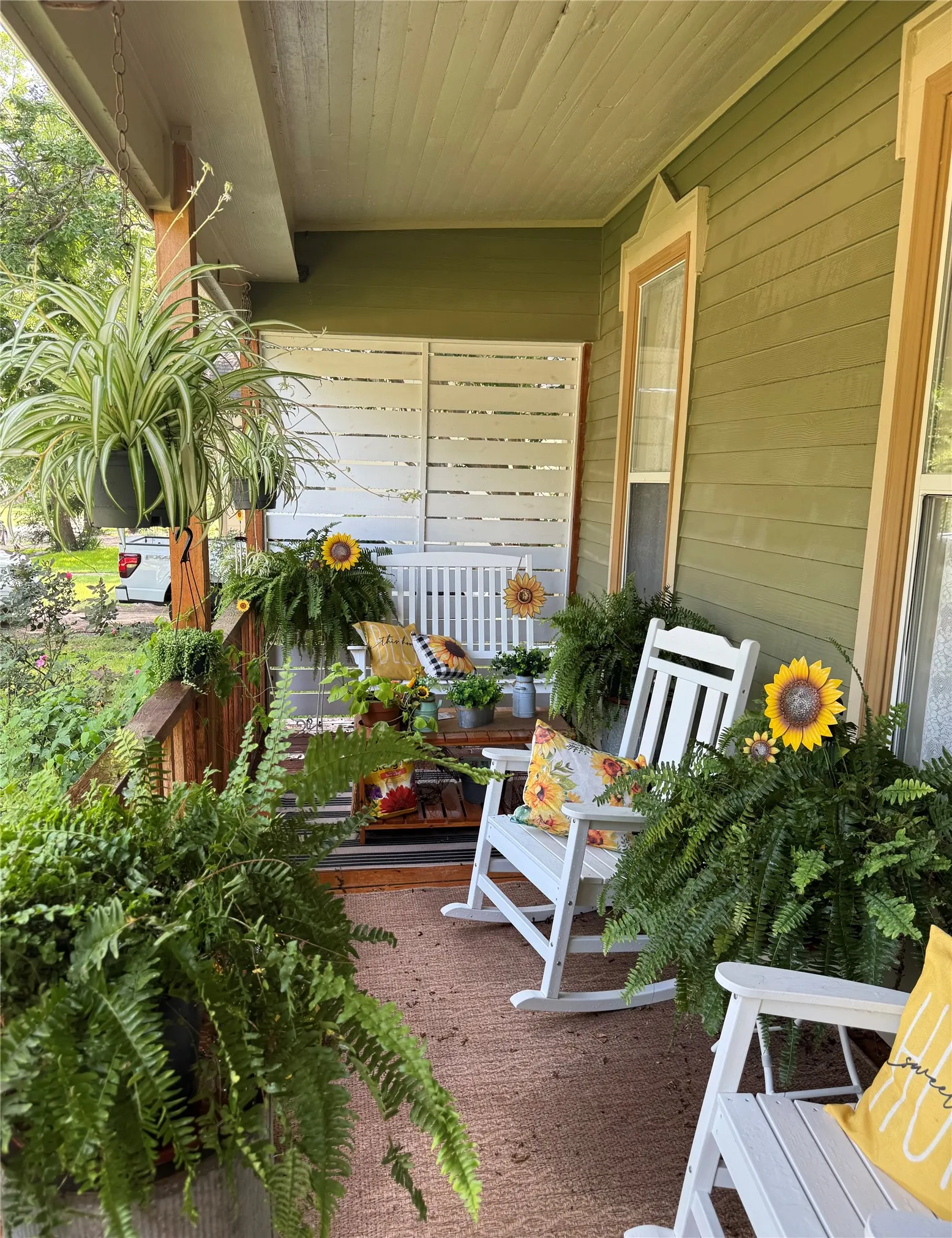 Inviting covered front porch with painted wood siding and a beadboard ceiling