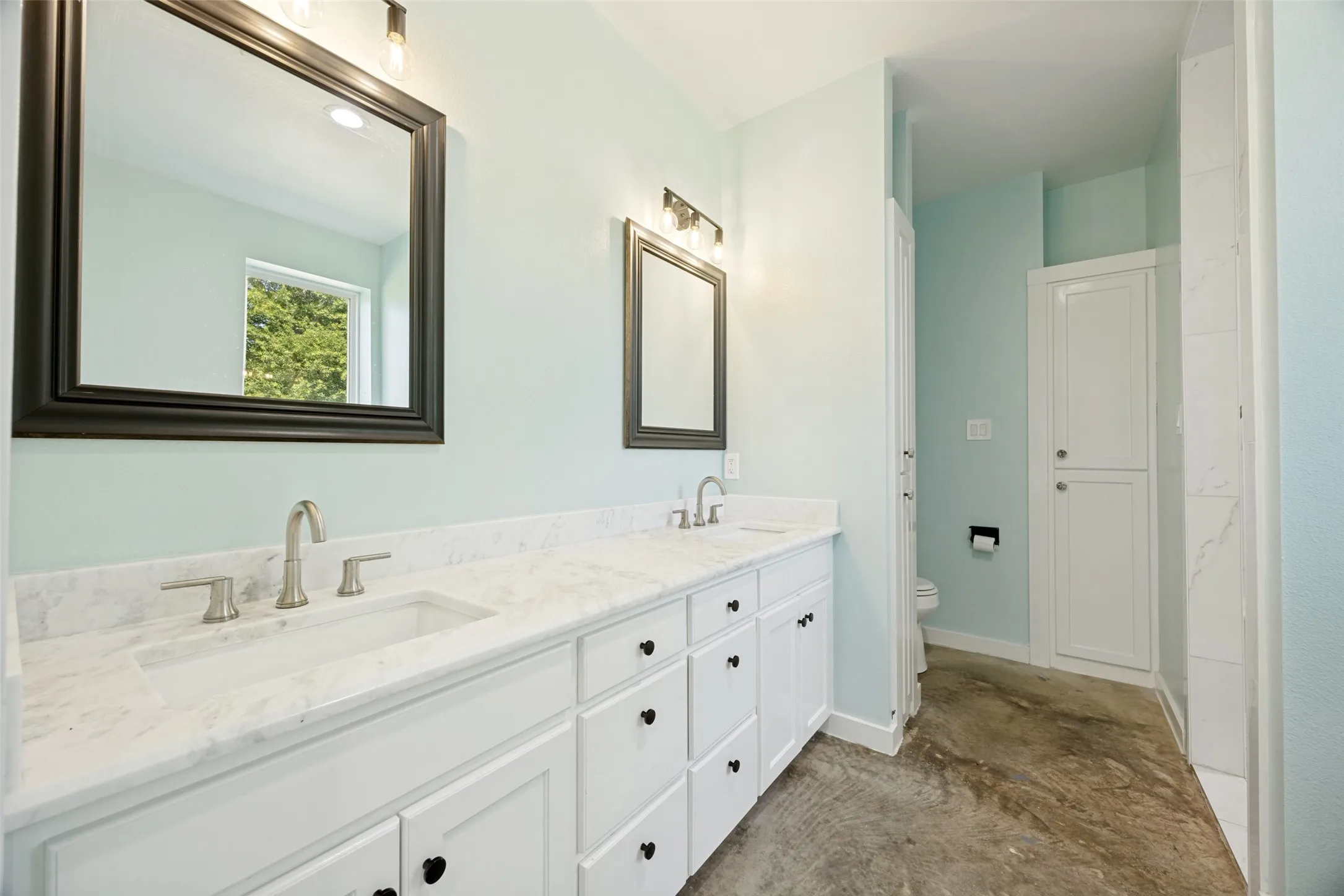 Dual vanity with integral sinks and white stone-finish countertops