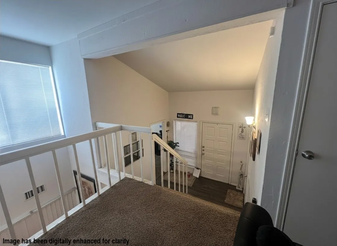 Virtually Enhanced- Upper-level landing featuring carpeted flooring and white painted railings