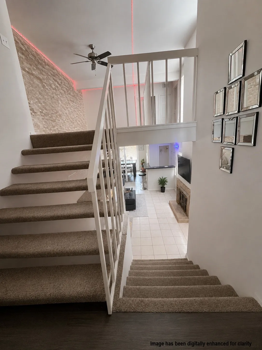 Virtually Enhanced- Split-level interior featuring carpeted stairs and a white railing system