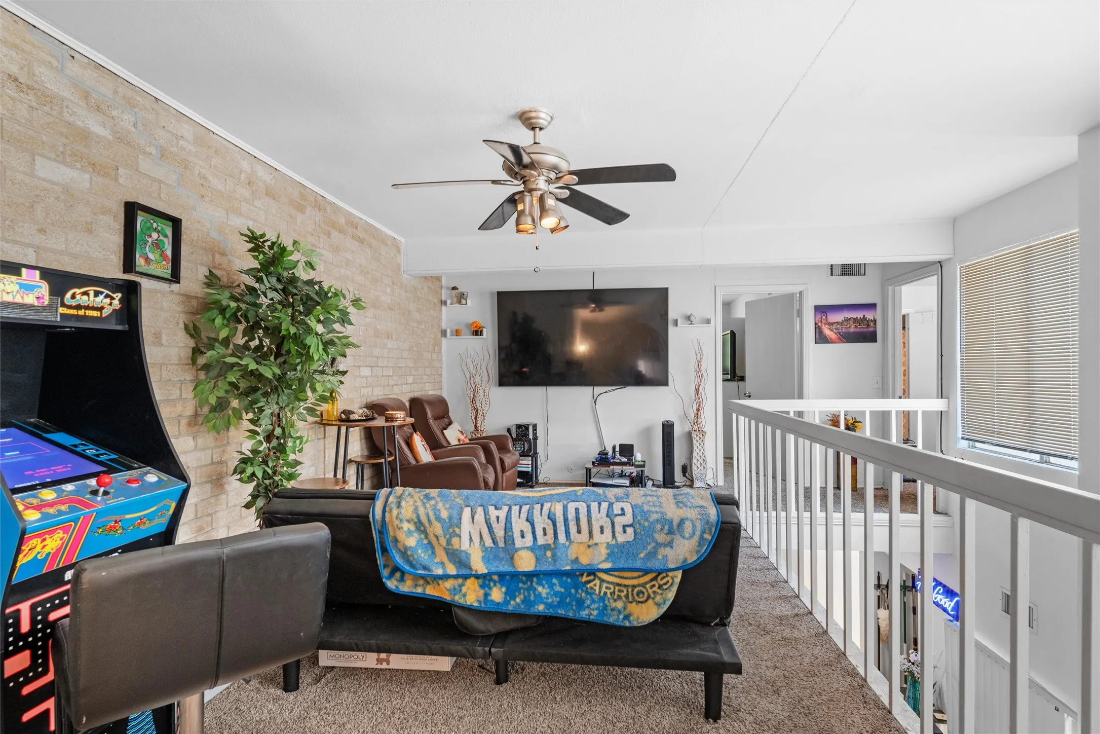 Upper-level landing- Game Room featuring carpeted flooring and white painted railings
