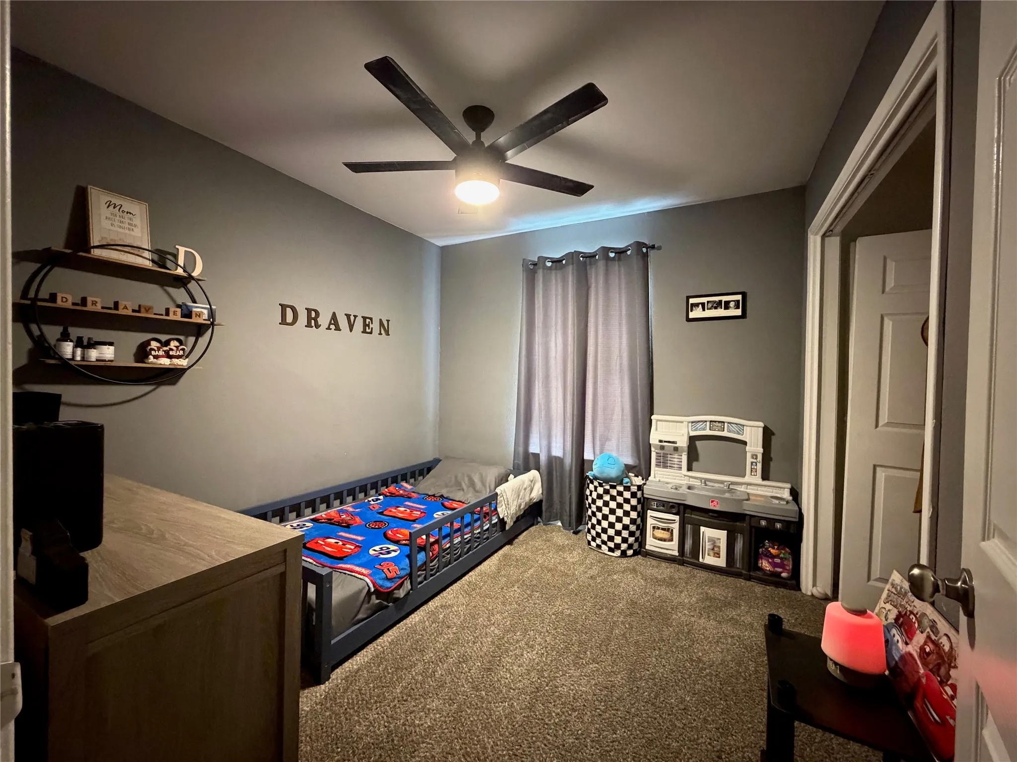 Neutral gray wall paint with a ceiling fan overhead