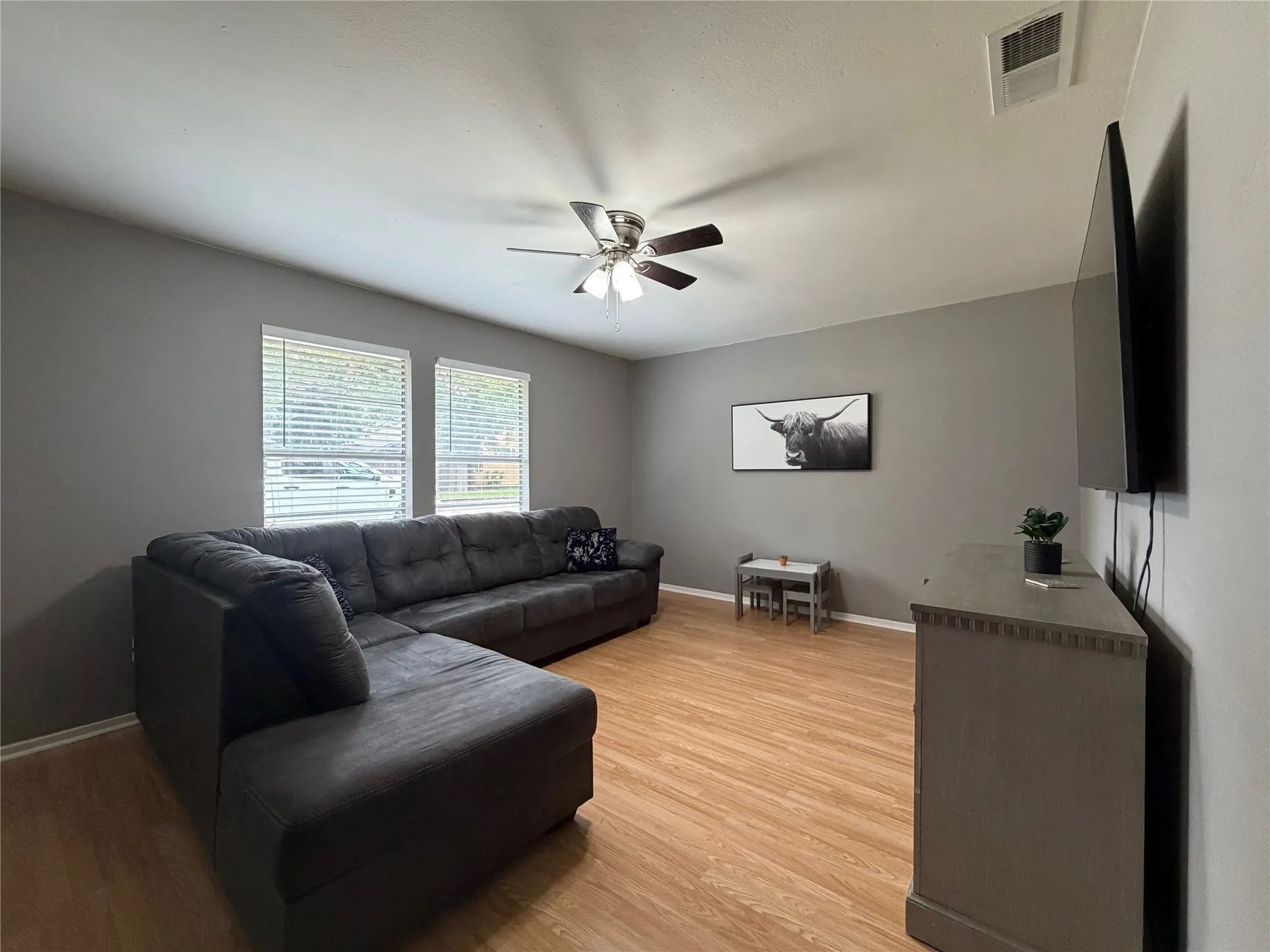 Living area featuring wood-finish flooring and neutral gray walls