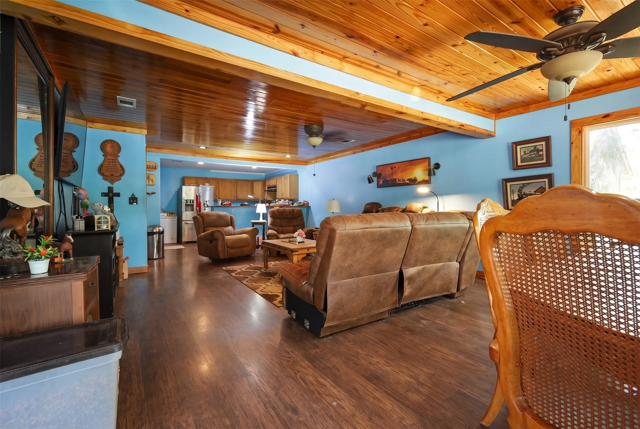 Open-concept living area featuring wood-finish flooring, a wood-plank ceiling, and recessed lighting