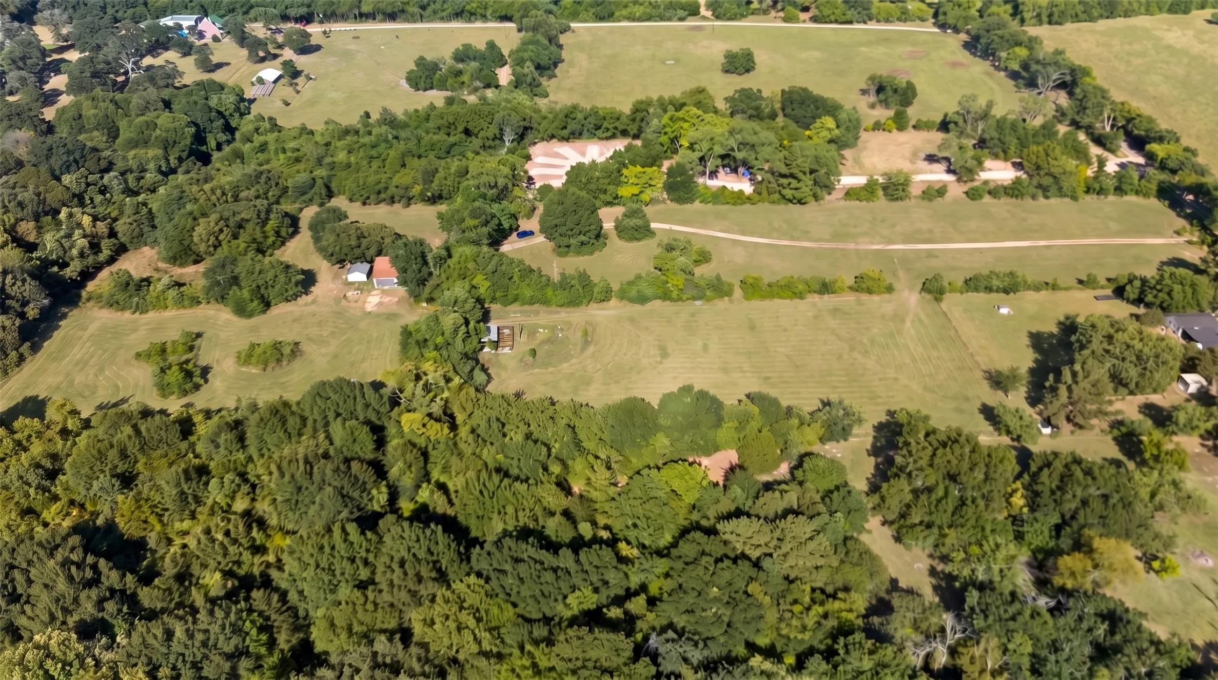 Expansive property featuring a mix of mature trees and cleared land