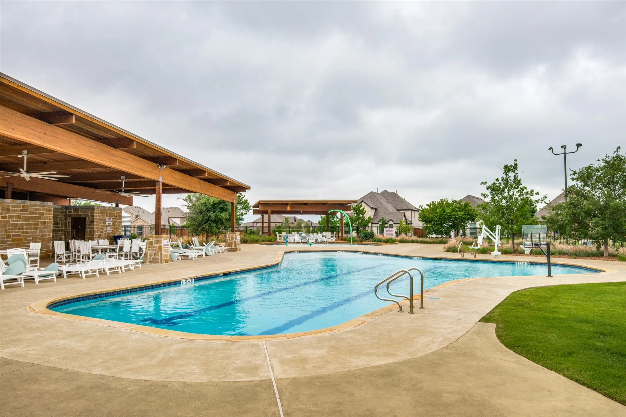 Expansive outdoor swimming pool with integrated lap lanes and concrete surround