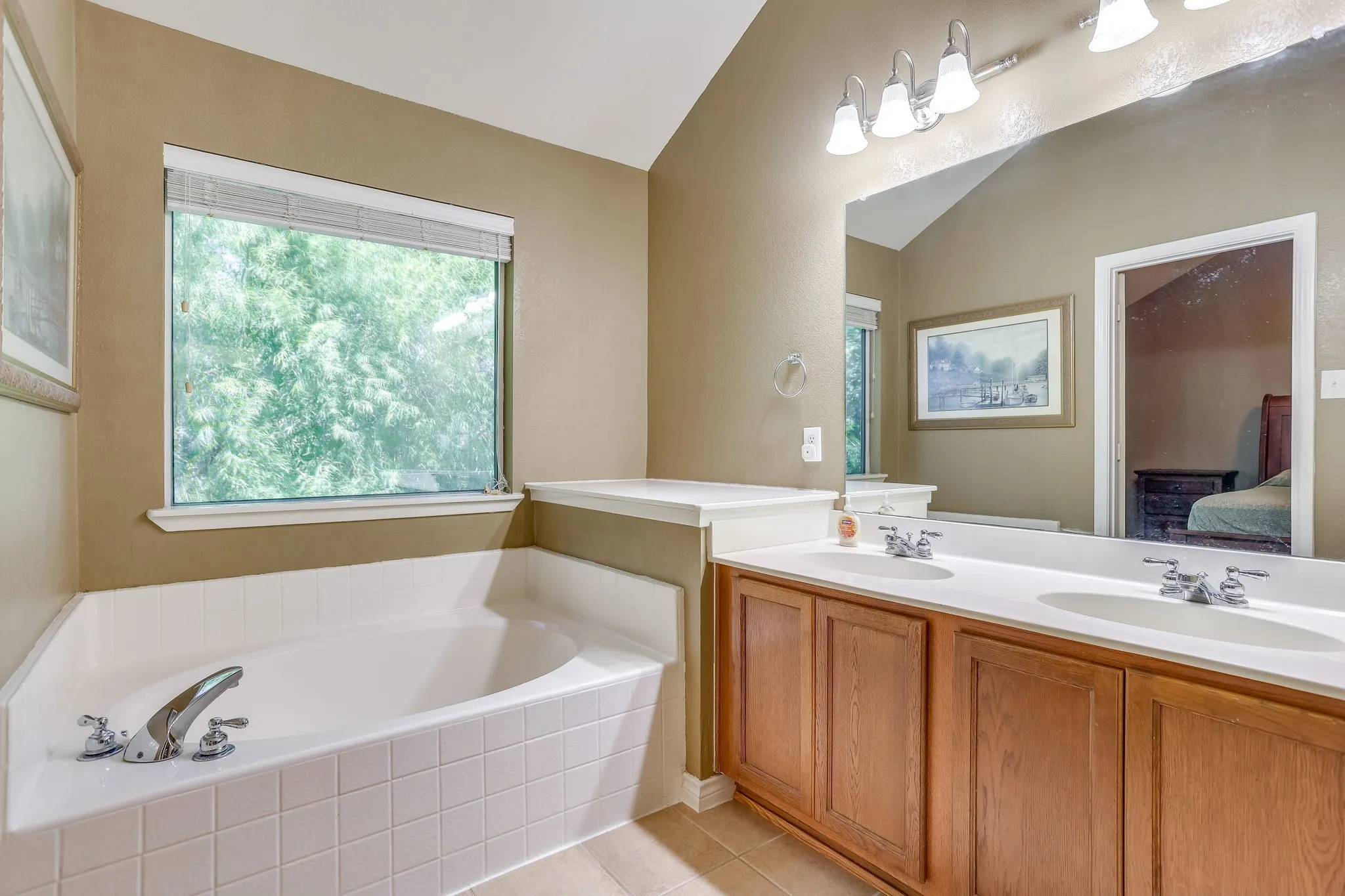 Oversized soaking tub double sink vanity and separate shower with overhead lighting