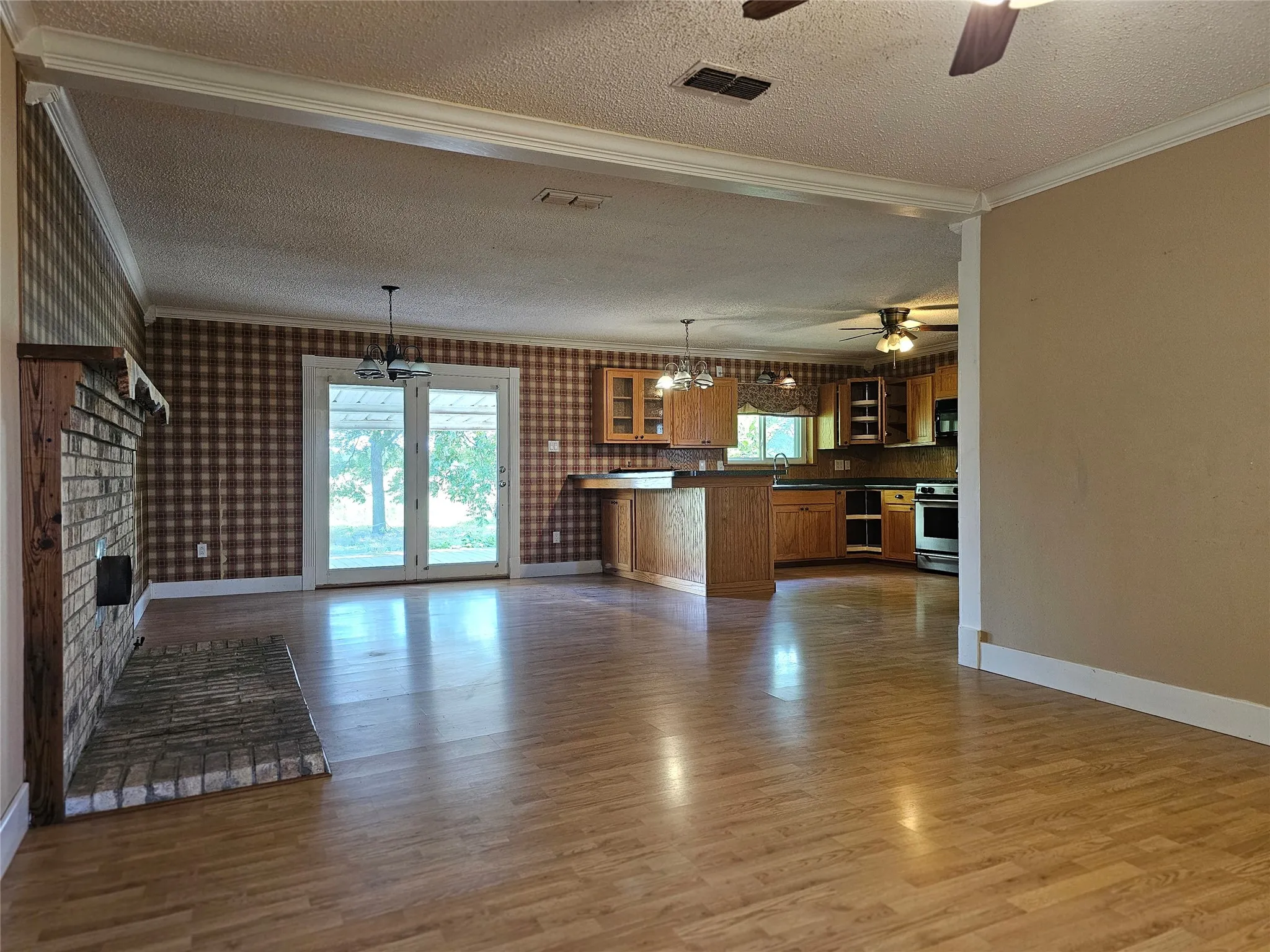 View of living room, kitchen, and dining area.