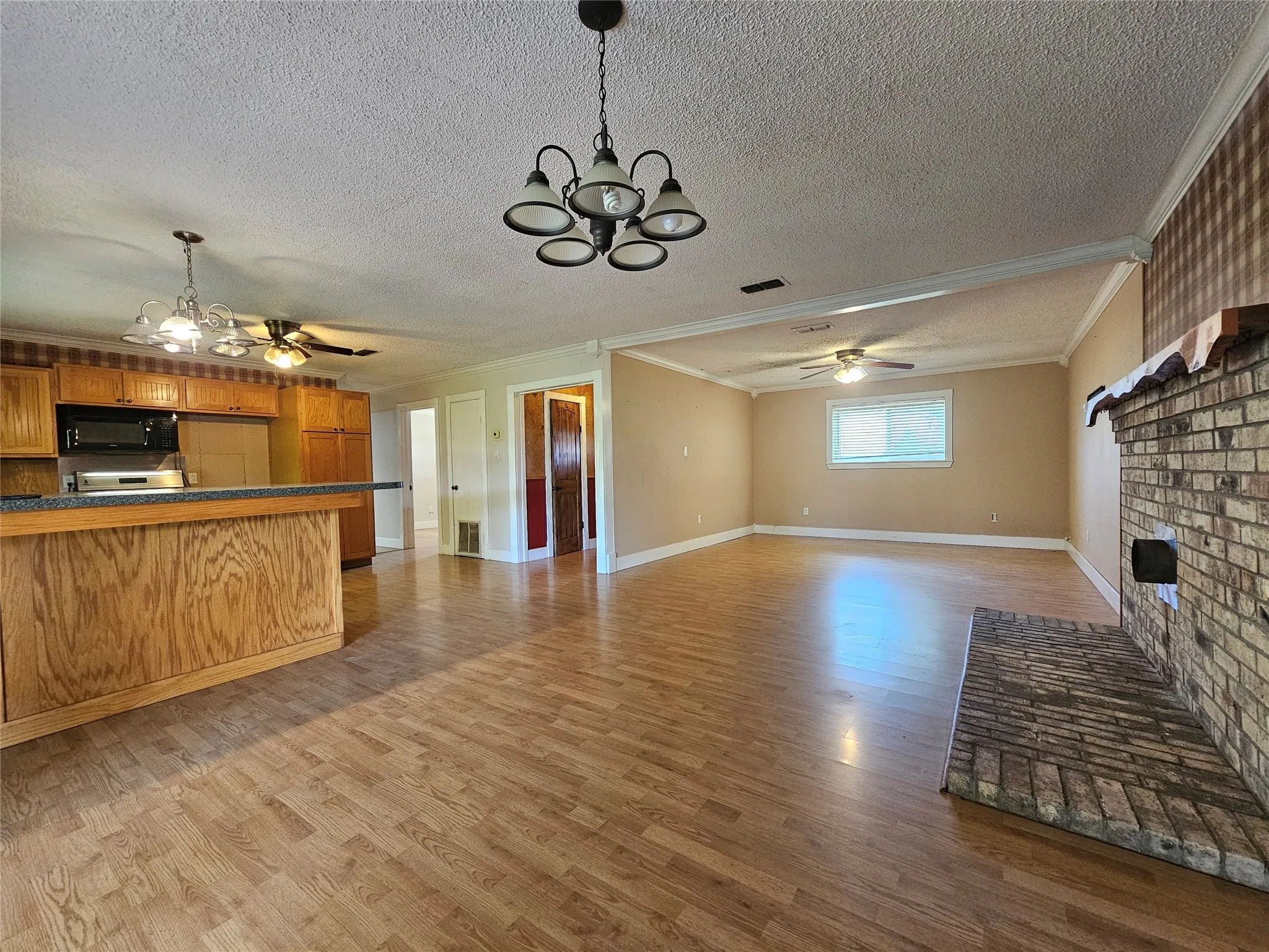 View of living room, kitchen, and dining area.