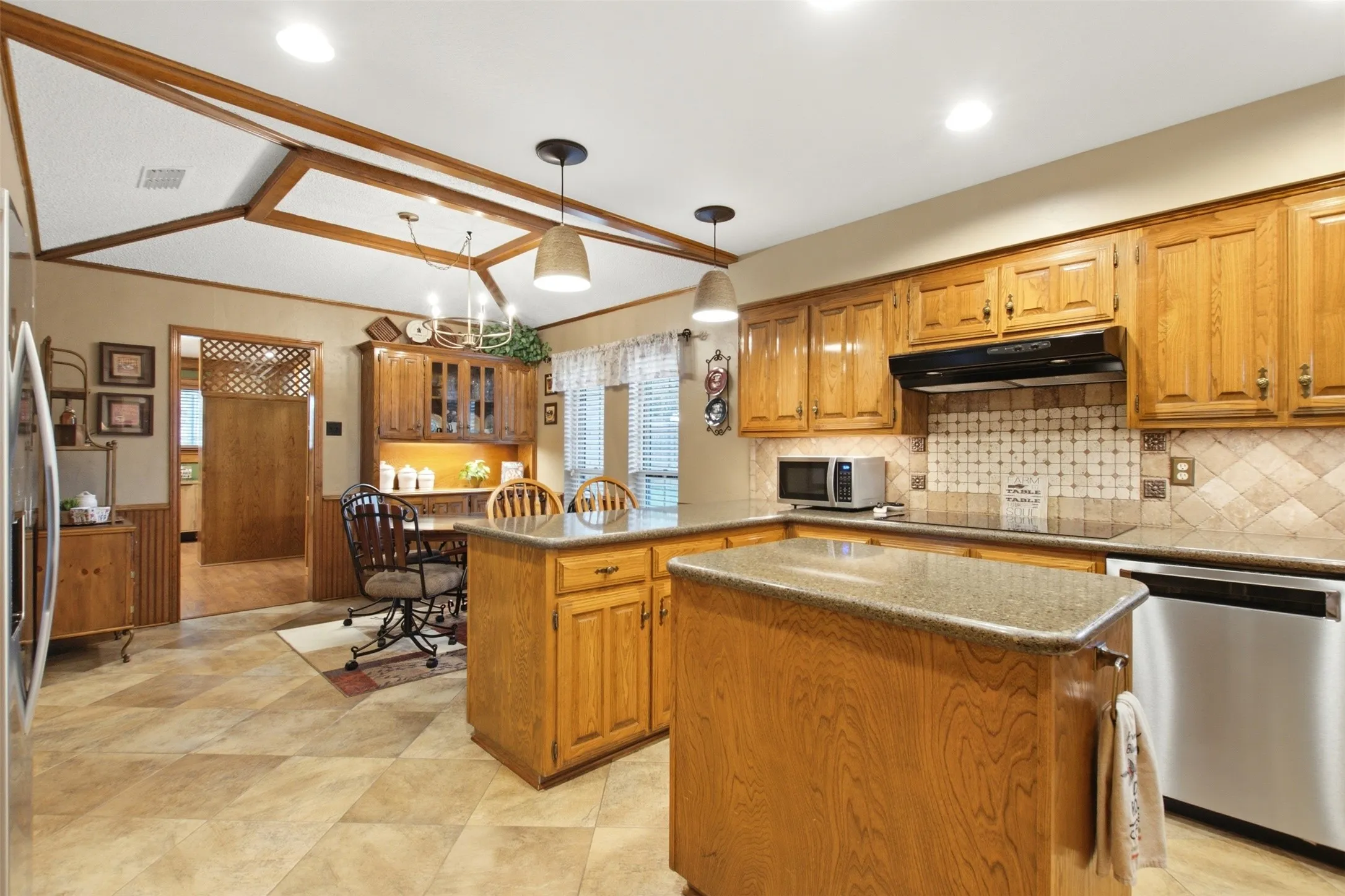 Spacious kitchen featuring warm wood cabinetry and a central island