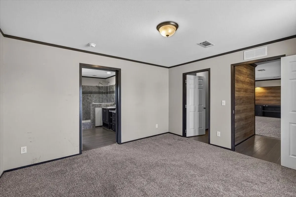 Another view of the primary bedroom with views of the bathroom