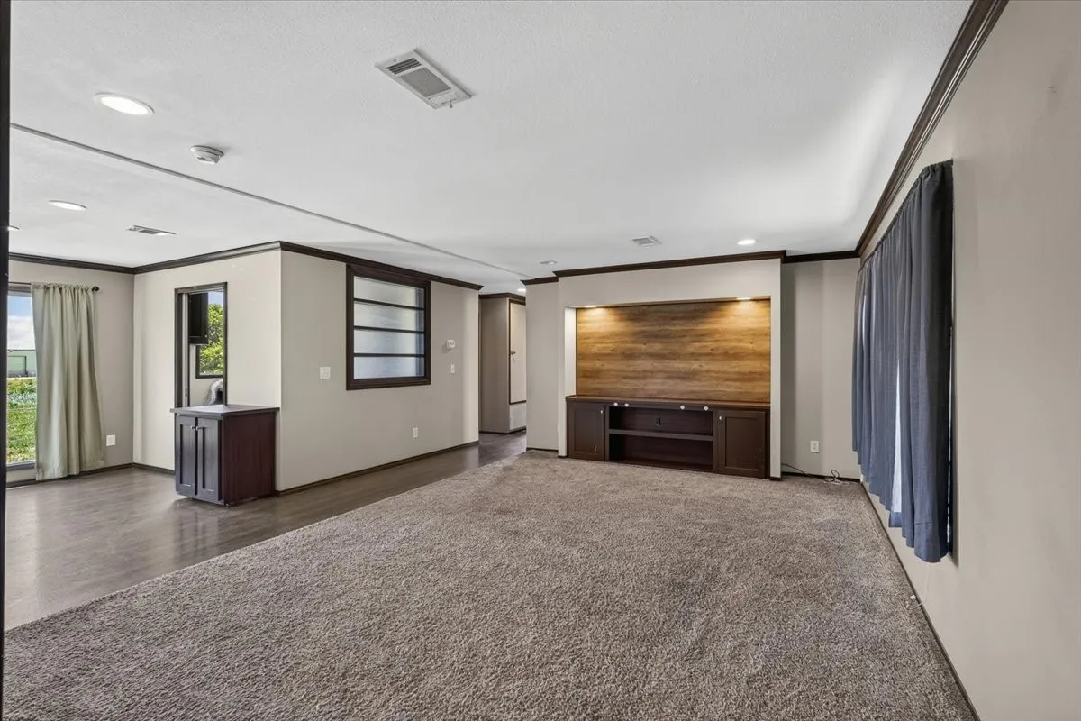 Living space with built ins and wood accent on the wall