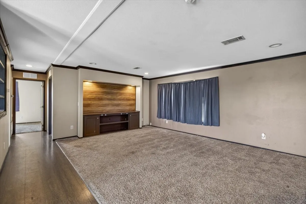 Another view of the living with with vinyl flooring in the high traffic area