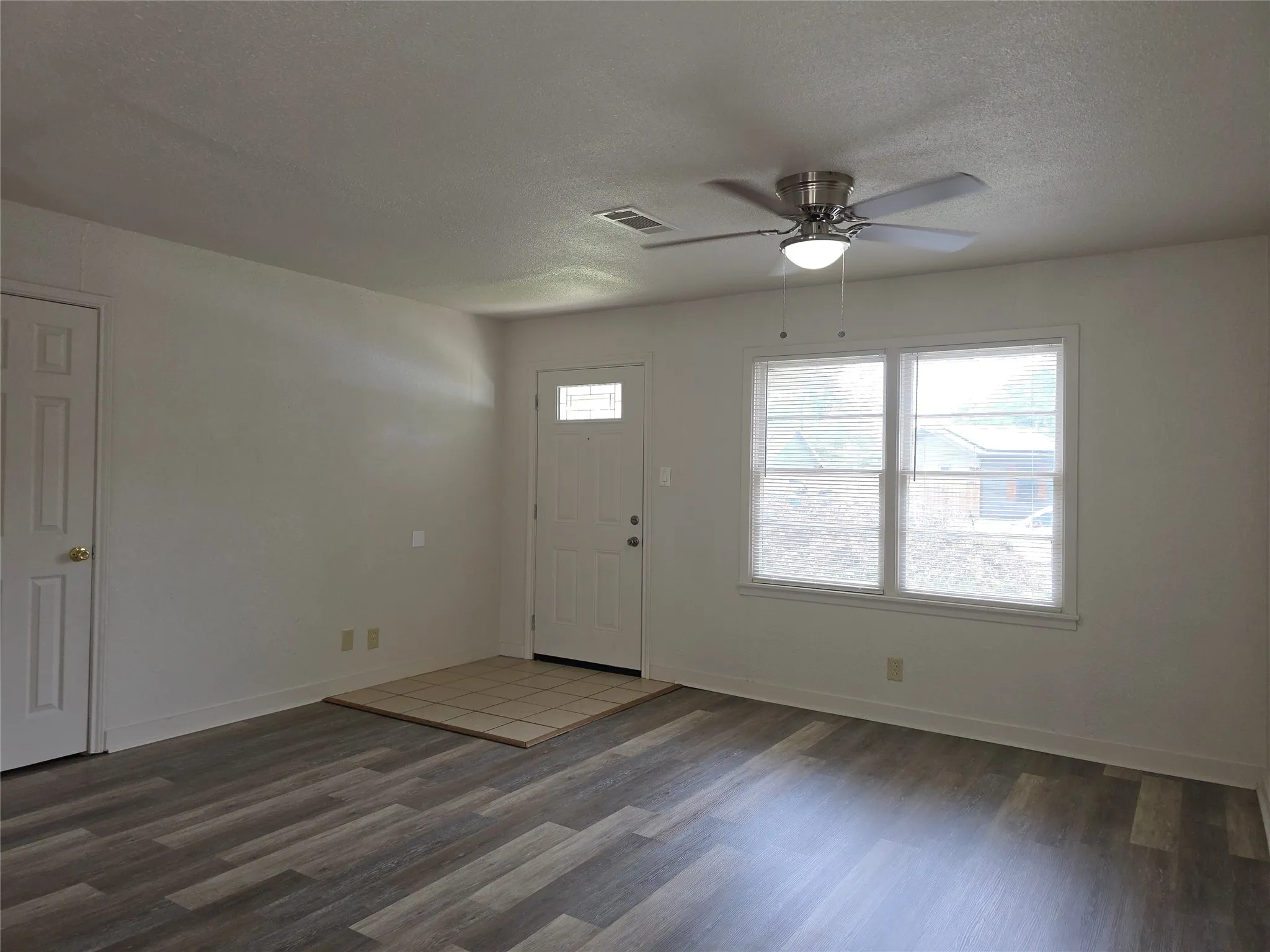 Bright interior space featuring wood-finish flooring and a neutral color palette