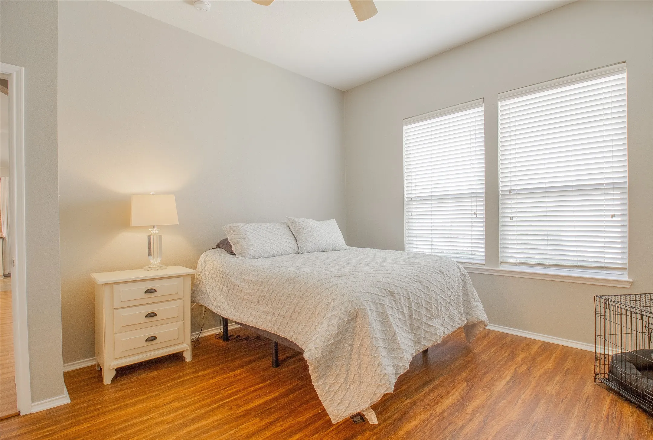 Room featuring warm wood-finish flooring and light-toned walls