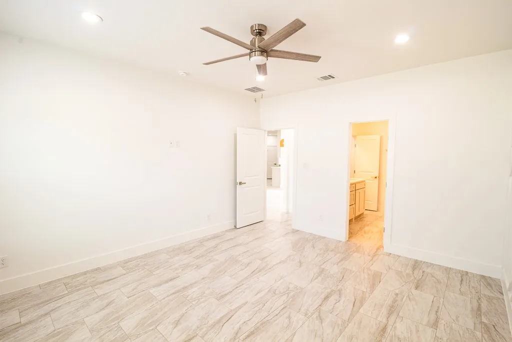 Spacious room featuring wood-finish flooring, recessed lighting, and a ceiling fan with brushed nickel finish