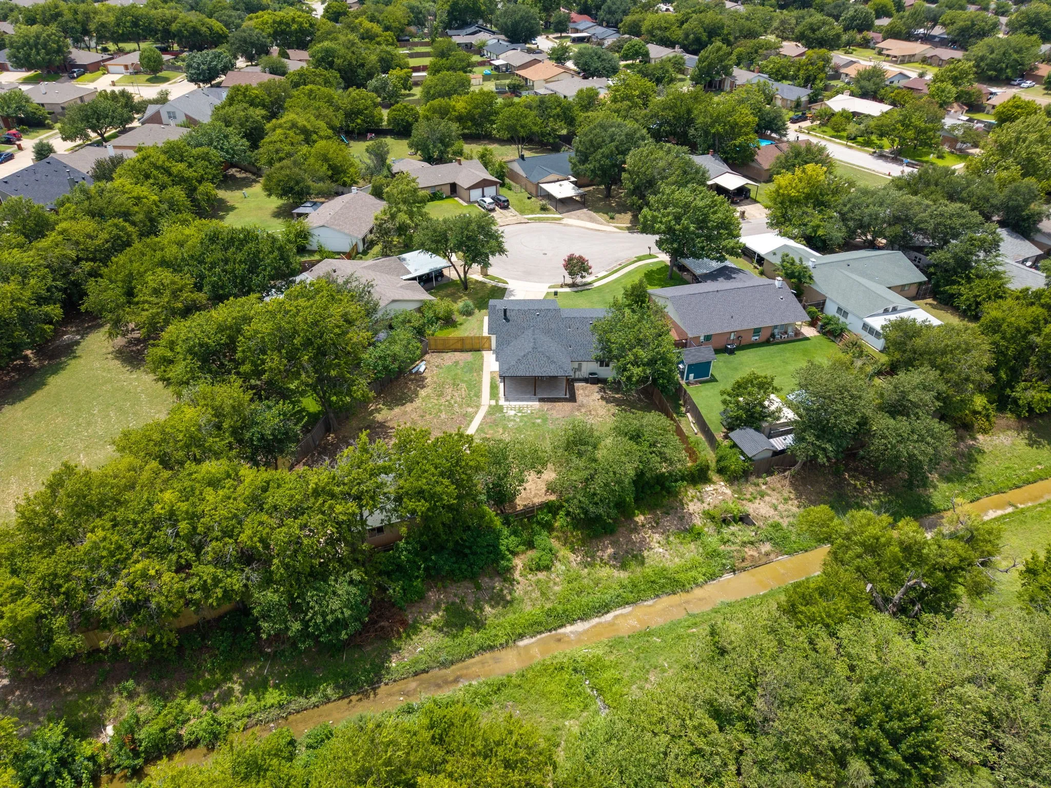 Aerial perspective showcasing the residential neighborhood with ample green space