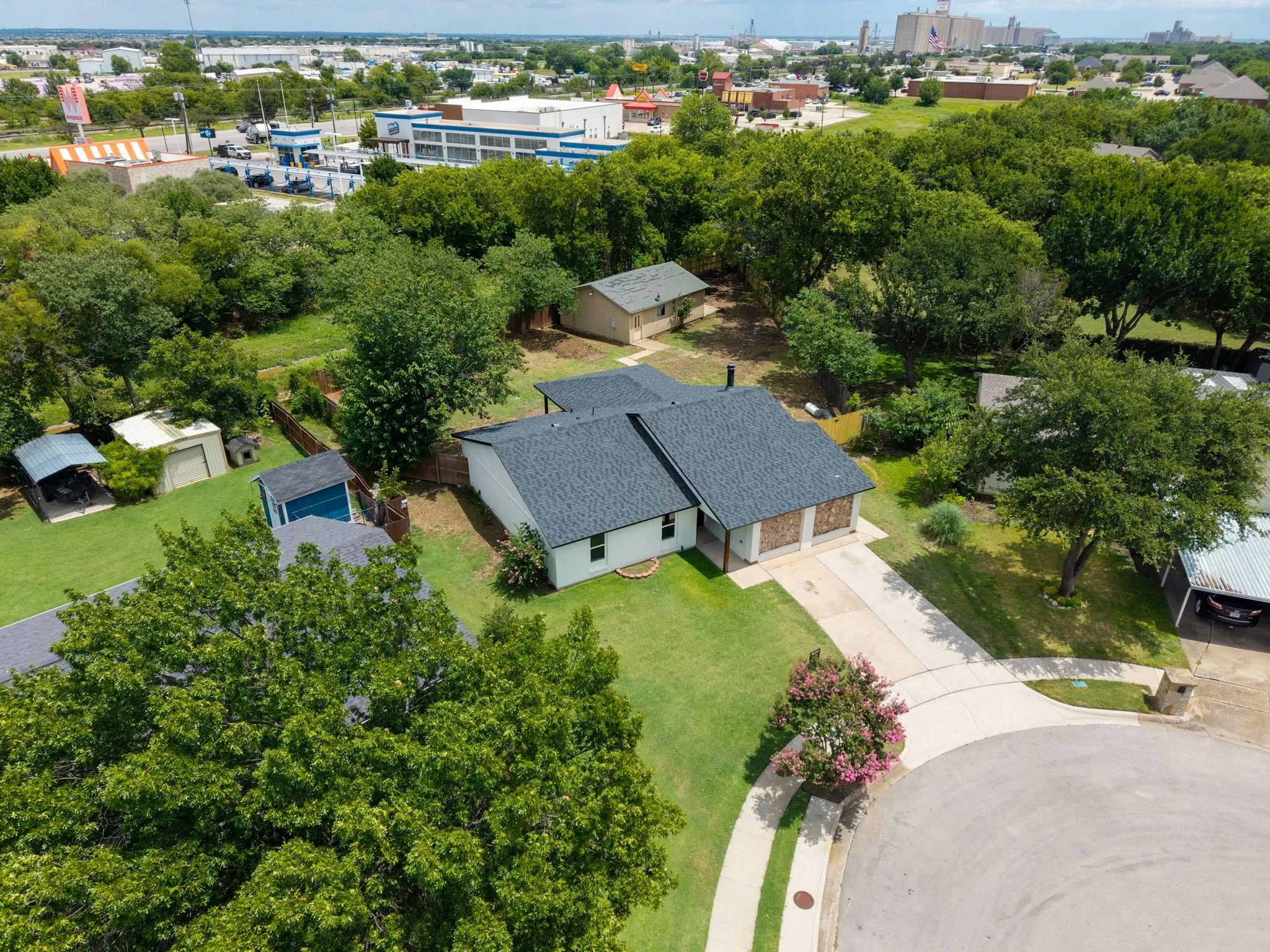 Single-story residence featuring a dark shingle roof and a two-car garage