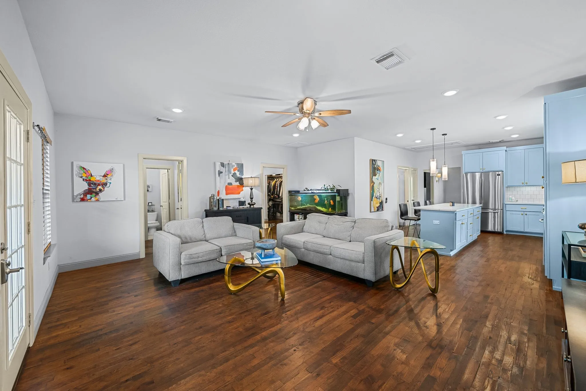 Expansive living area featuring wood-finish flooring and light-toned walls