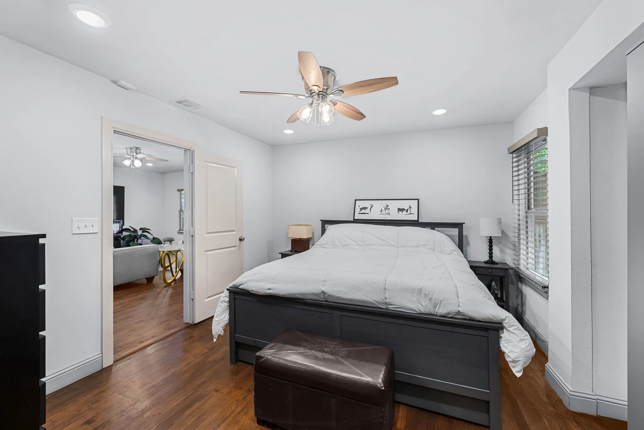 Bright bedroom featuring wood-finish flooring, recessed lighting, a ceiling fan, and window blinds