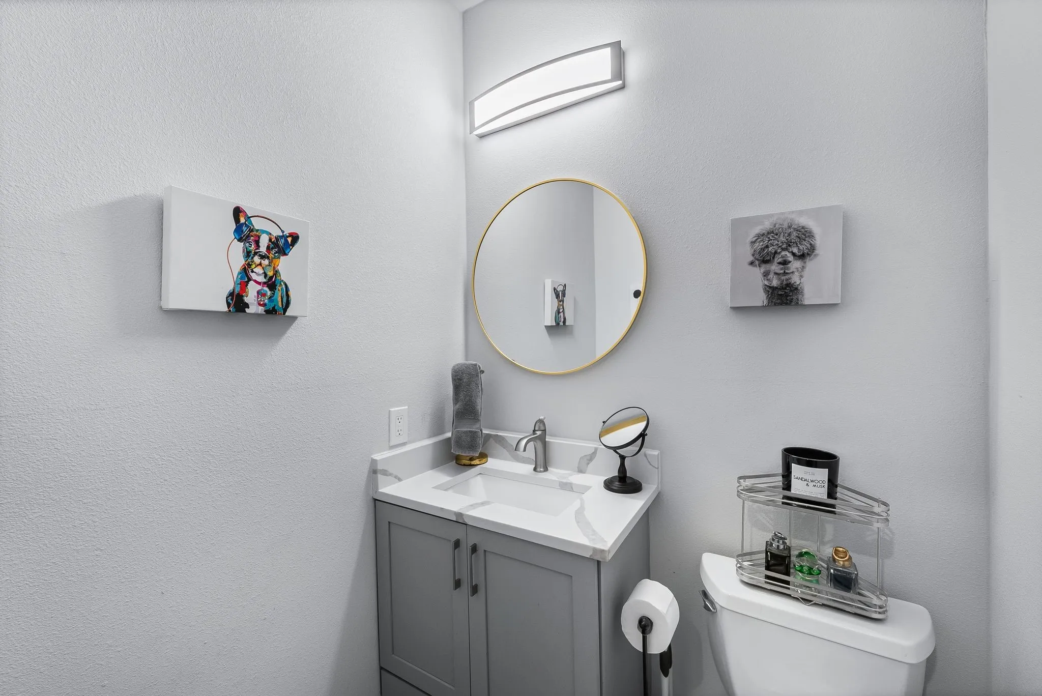 Vanity with gray cabinetry, white countertop, and integrated sink