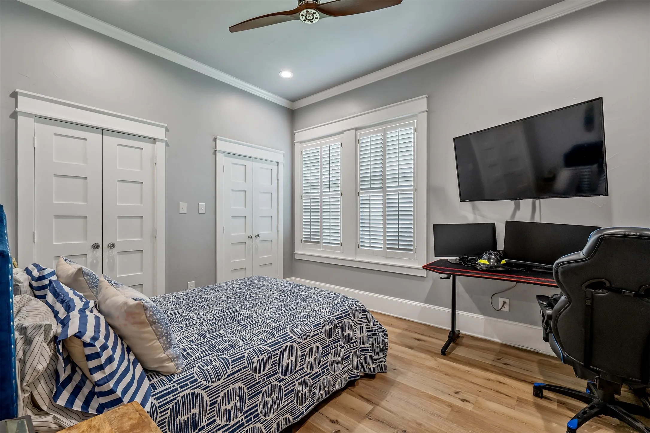 Bright room featuring wood-finish flooring and two sets of paneled bifold doors