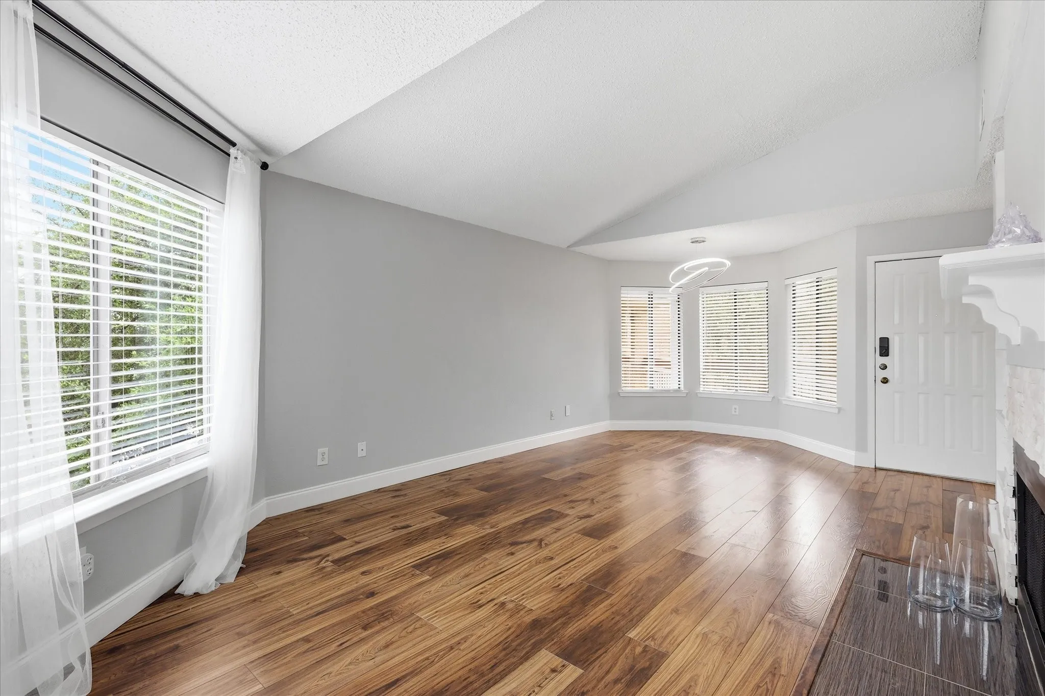 Spacious interior with vaulted ceilings and wood-finish flooring