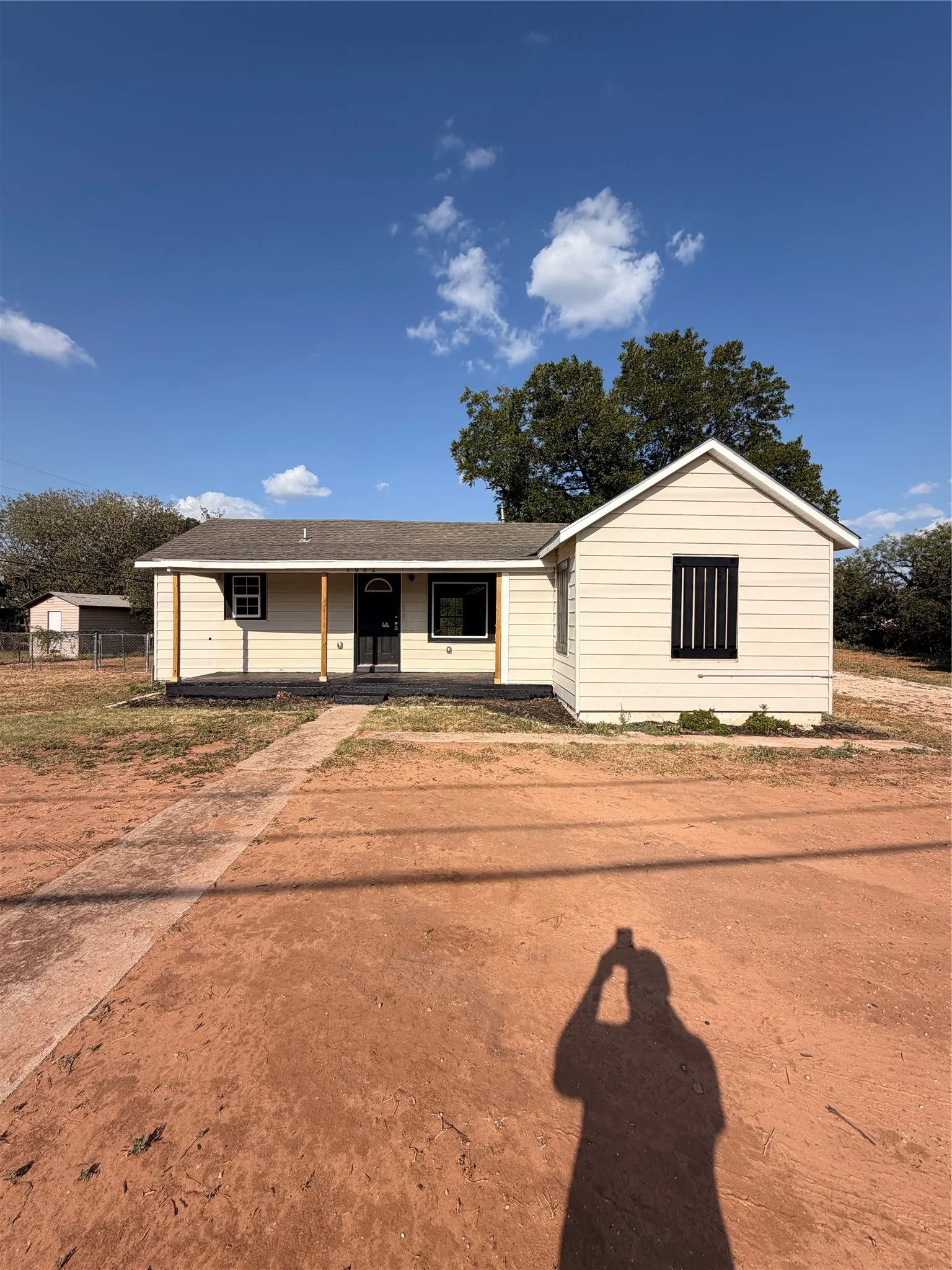 Light-colored siding exterior with dark trim accents