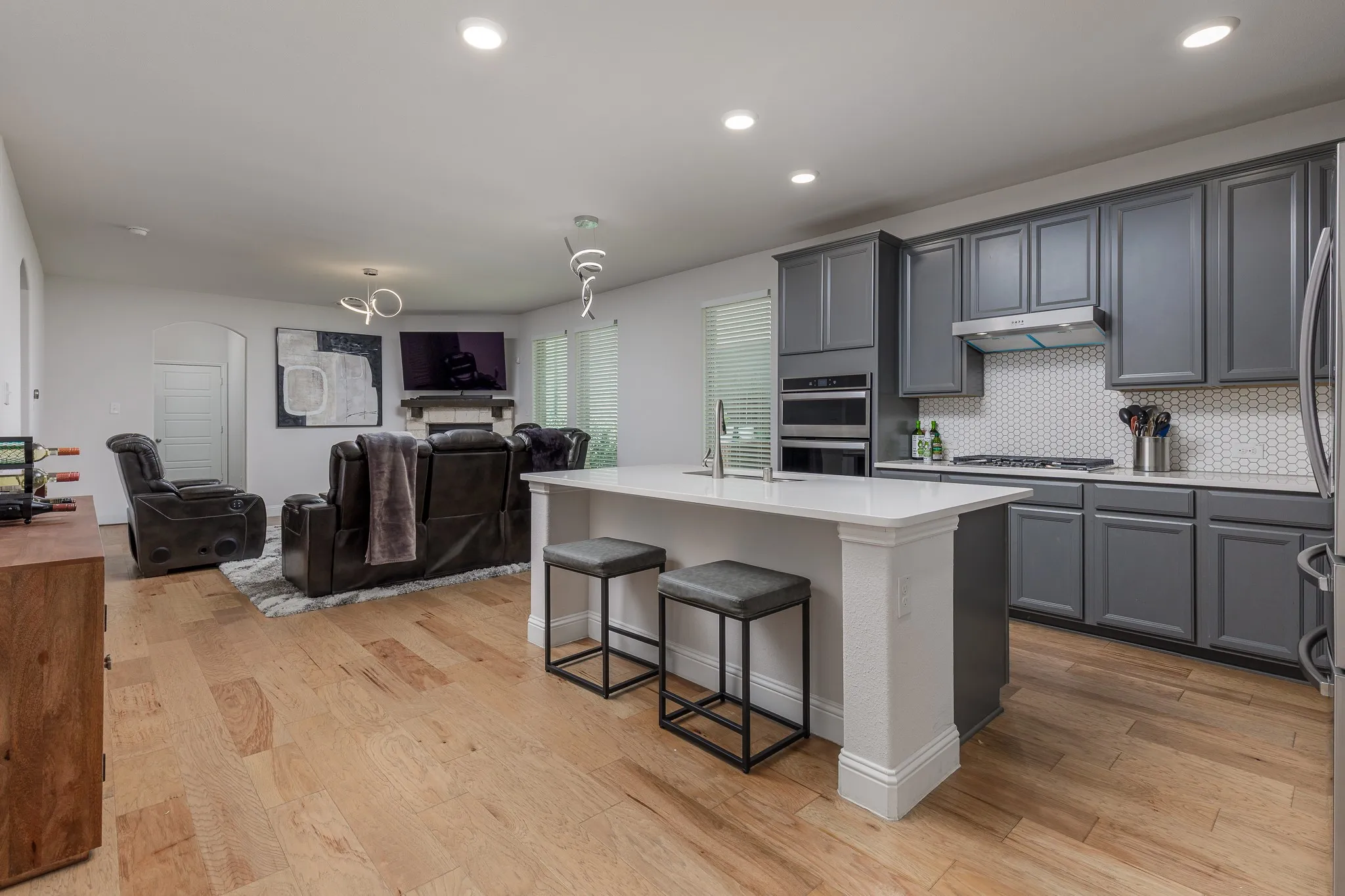 Open-concept kitchen and living area featuring wood-finish flooring