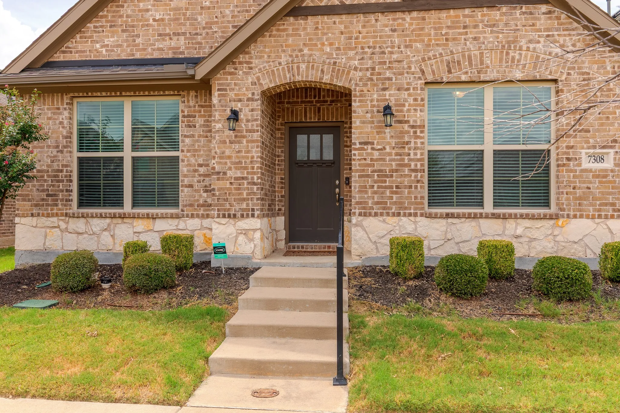 Brick facade with stone detailing and an arched entryway