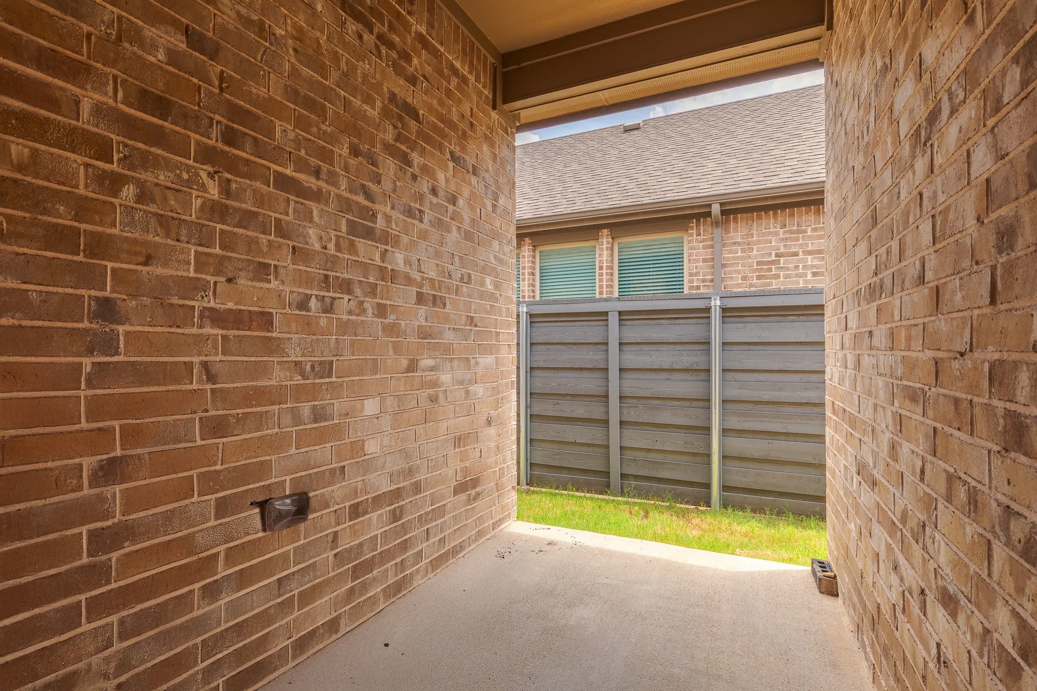 Brick exterior walls defining a covered outdoor passage
