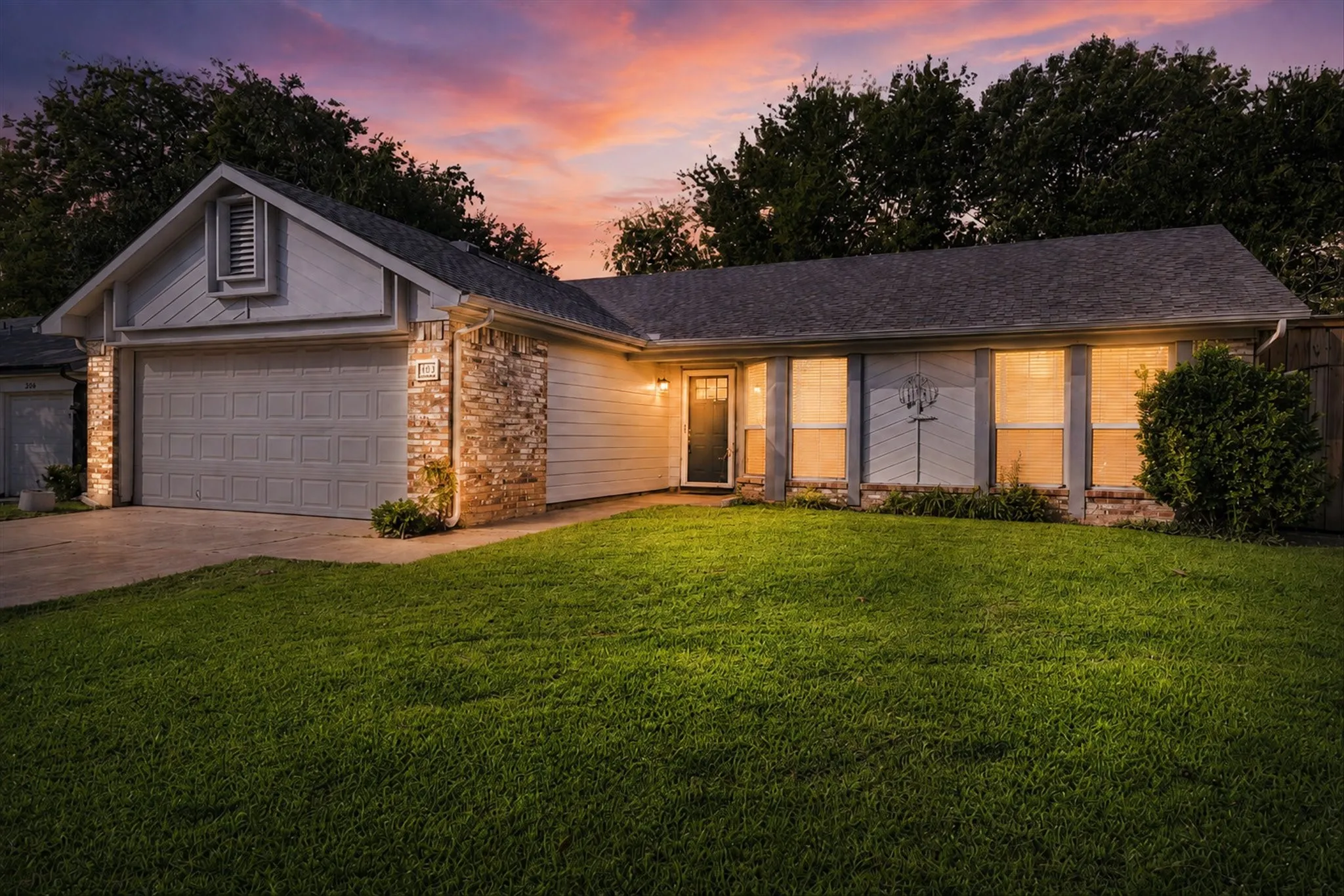 Single-story residence featuring a two-car garage and a front entry door with sidelights