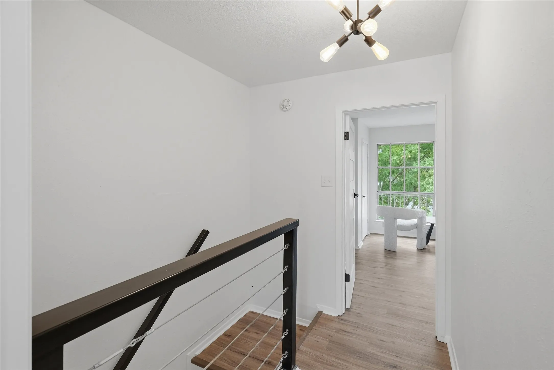 Contemporary staircase with metal cable railing and wood-finish treads