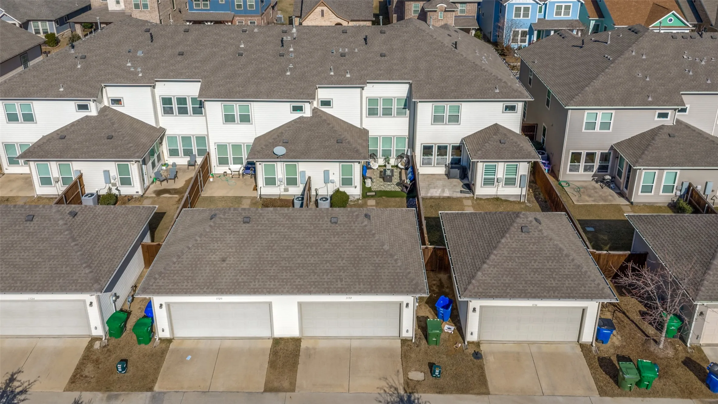 Modern residential development featuring a series of two-story homes with attached garages