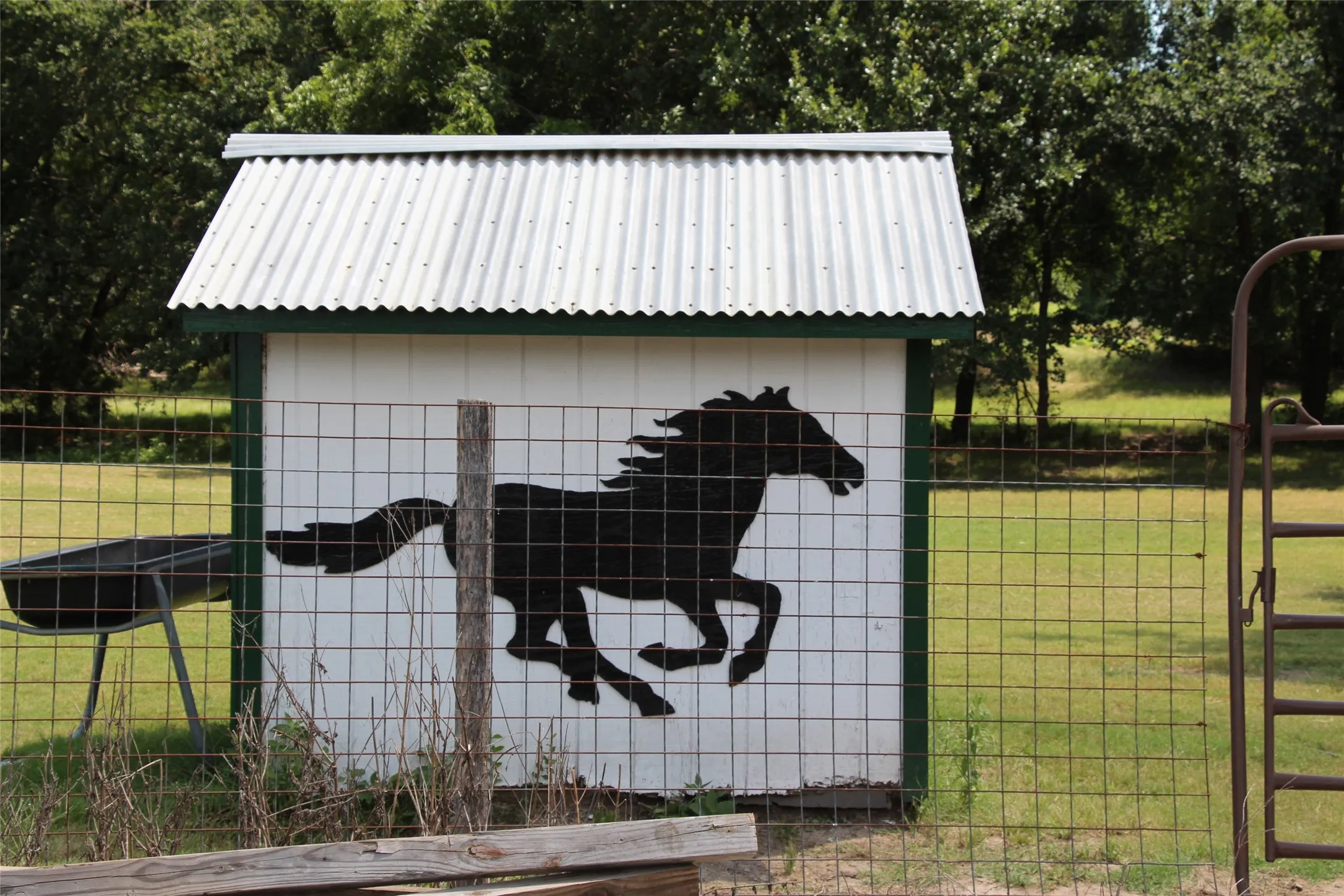 White well house with a corrugated metal roof