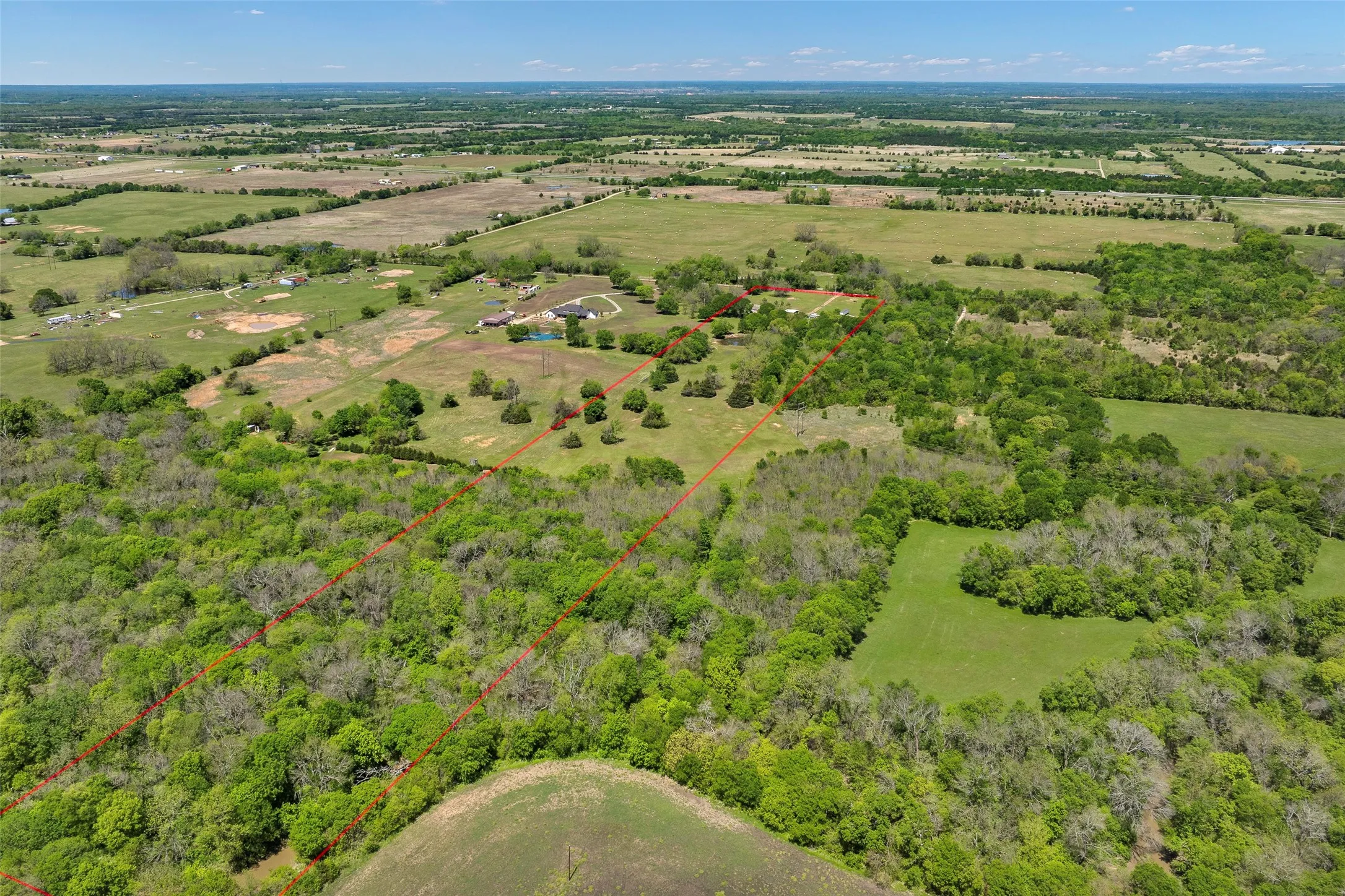 Expansive acreage featuring mature trees and open clearings