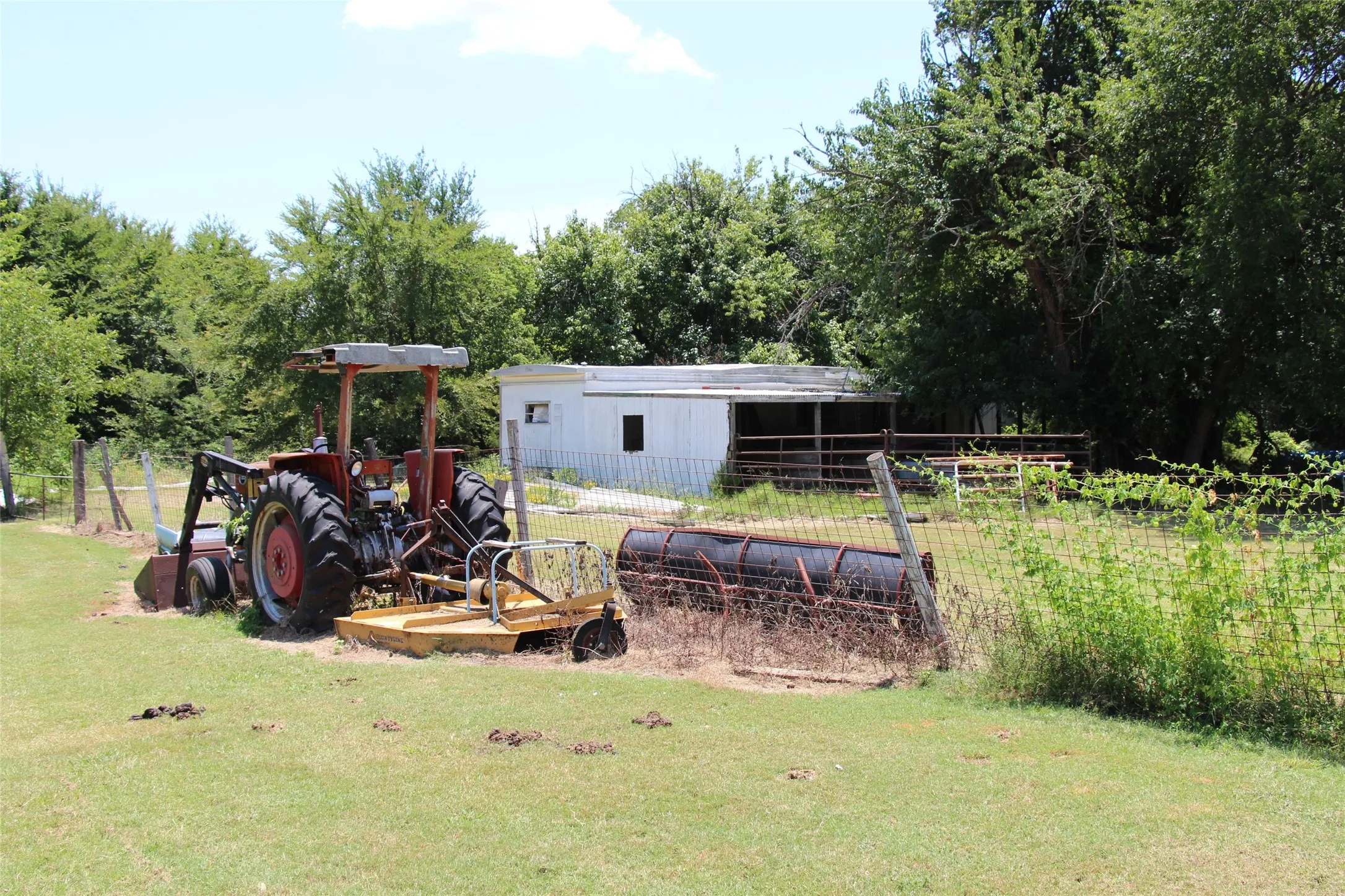 Beyond the tractor is 6 stall horse barn with hay storage.