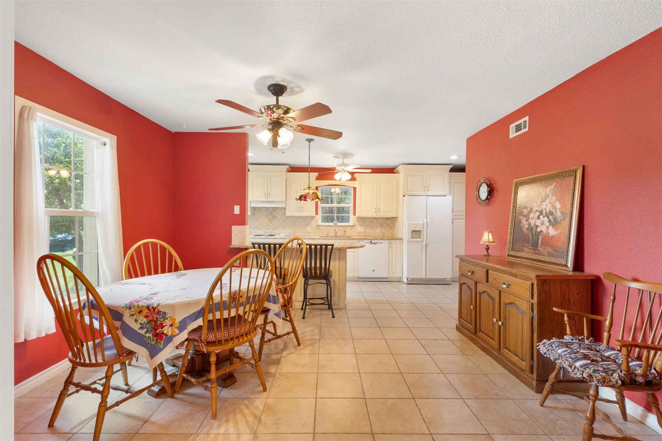 Significantly redesigned to create a desirable open-concept layout, this timeless kitchen features Travertine tile backsplash, abundant custom cabinetry and pantry, and a classic Granite island with bar seating with seamless flow in to the dining. Few people have this type of kitchen at this price point!
