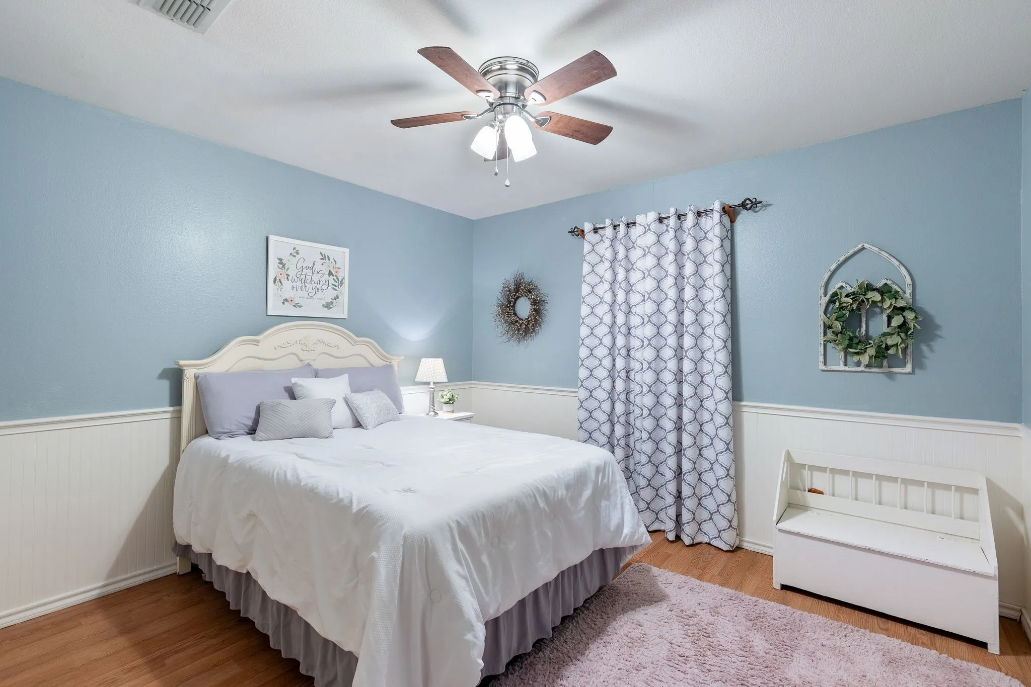 Bedroom with light hardwood / wood-style floors and ceiling fan