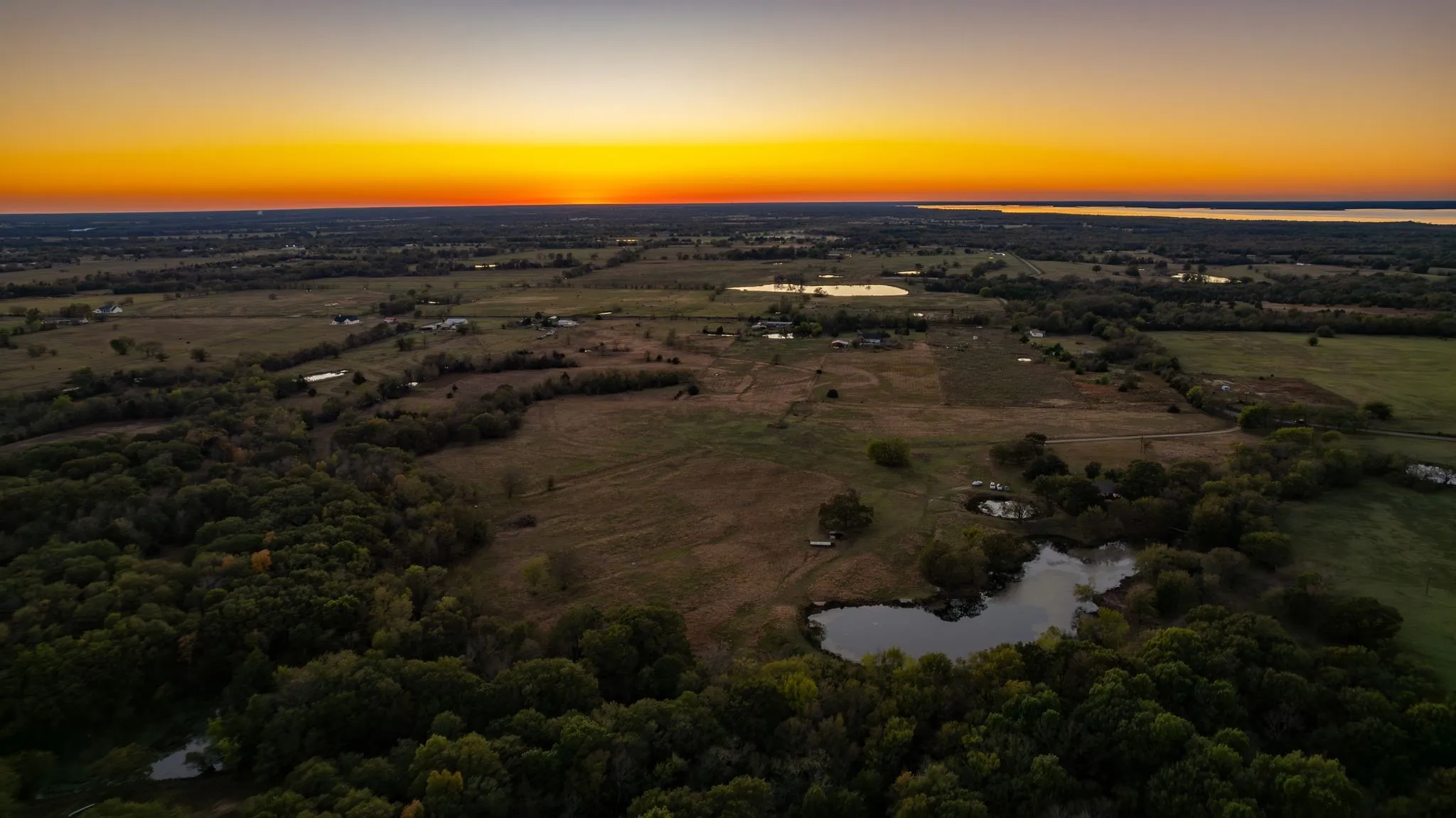 Aerial view at dusk featuring a water view
