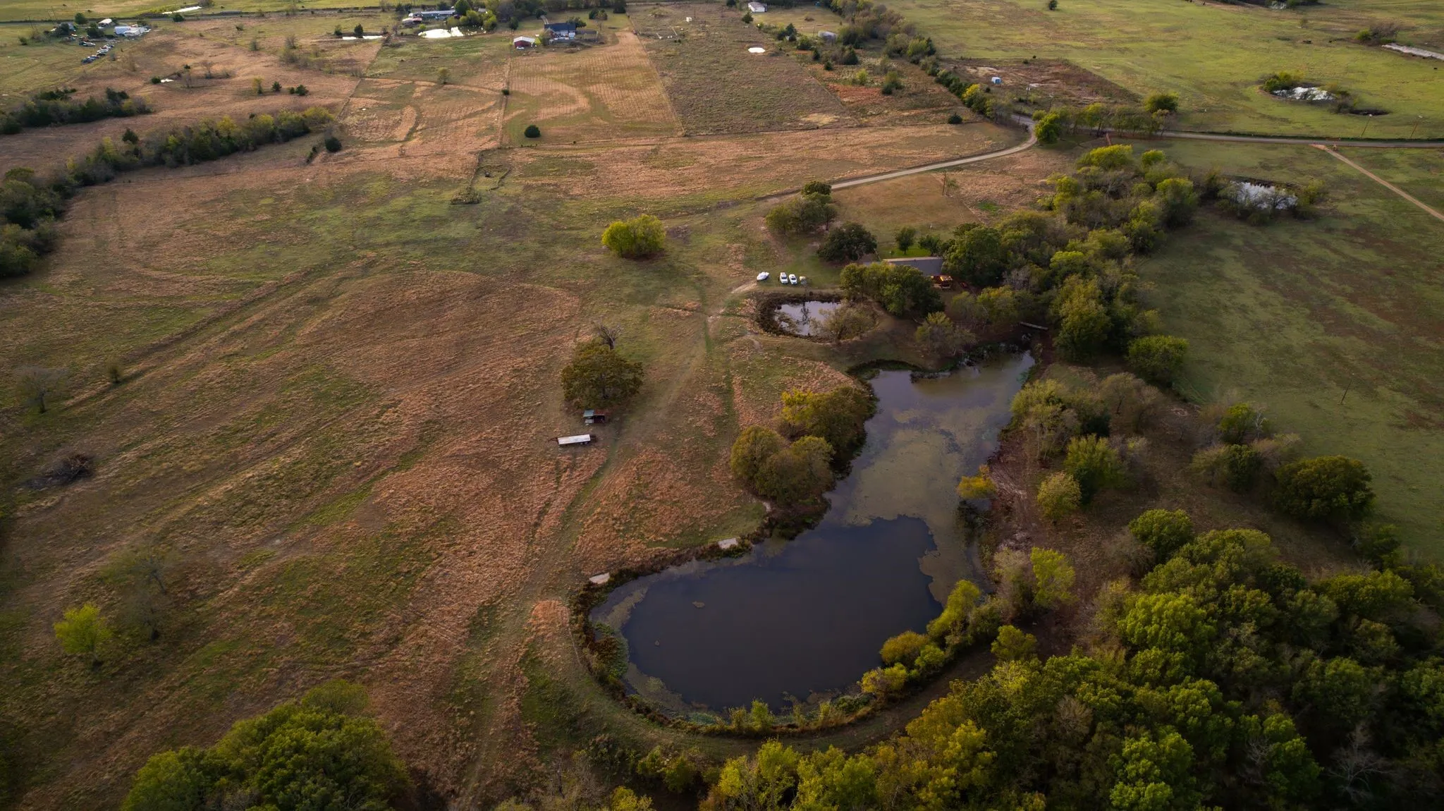 Birds eye view of property with a water view and a rural view