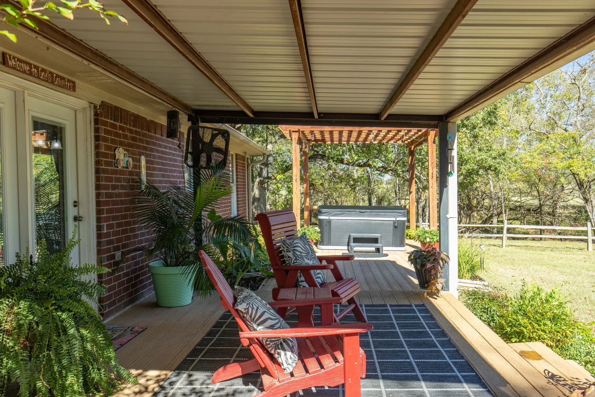View of patio / terrace featuring a wooden deck and a hot tub